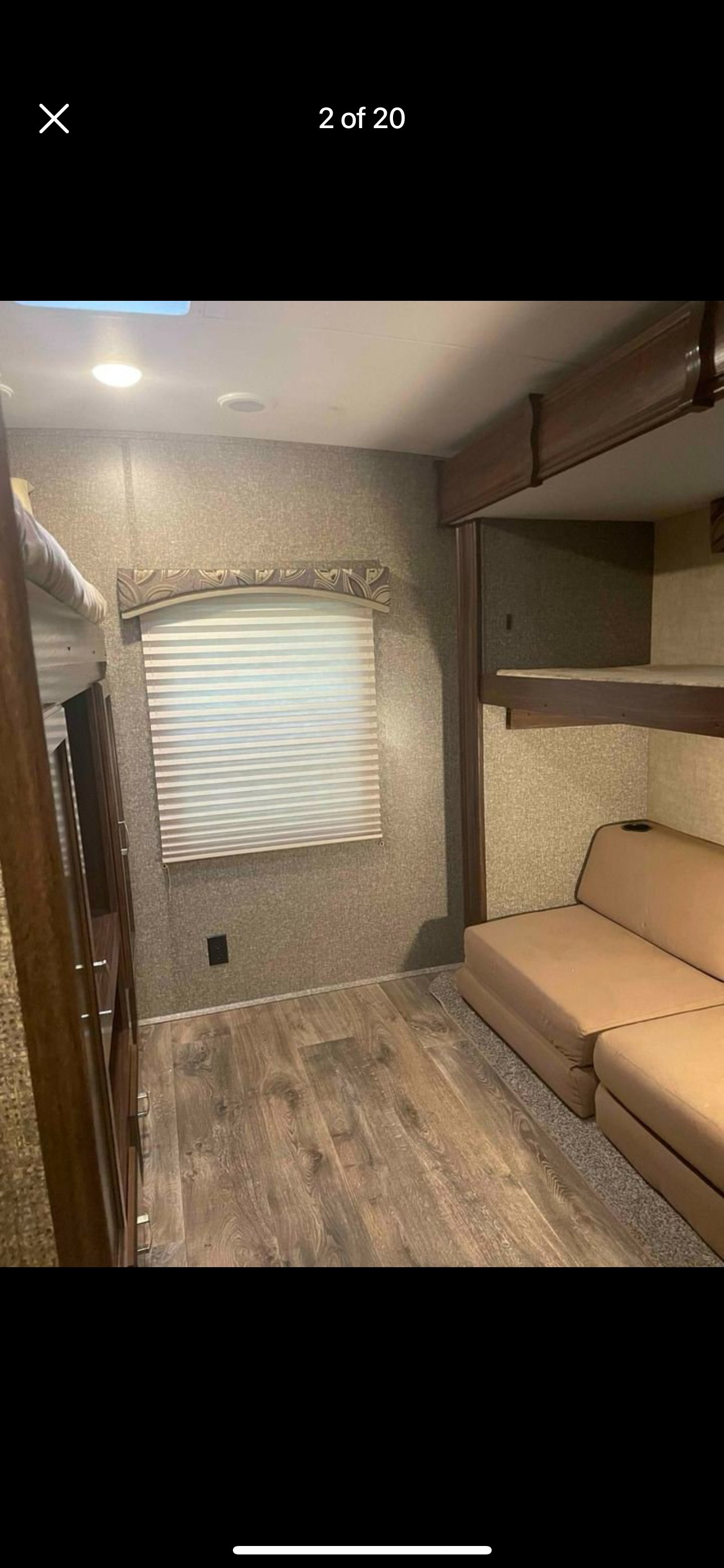 RV rental bunkhouse interior with comfy sofa, multiple bunks, and wood-look flooring. Great family camper space.. Heartland RVs Sundance XLT 2016