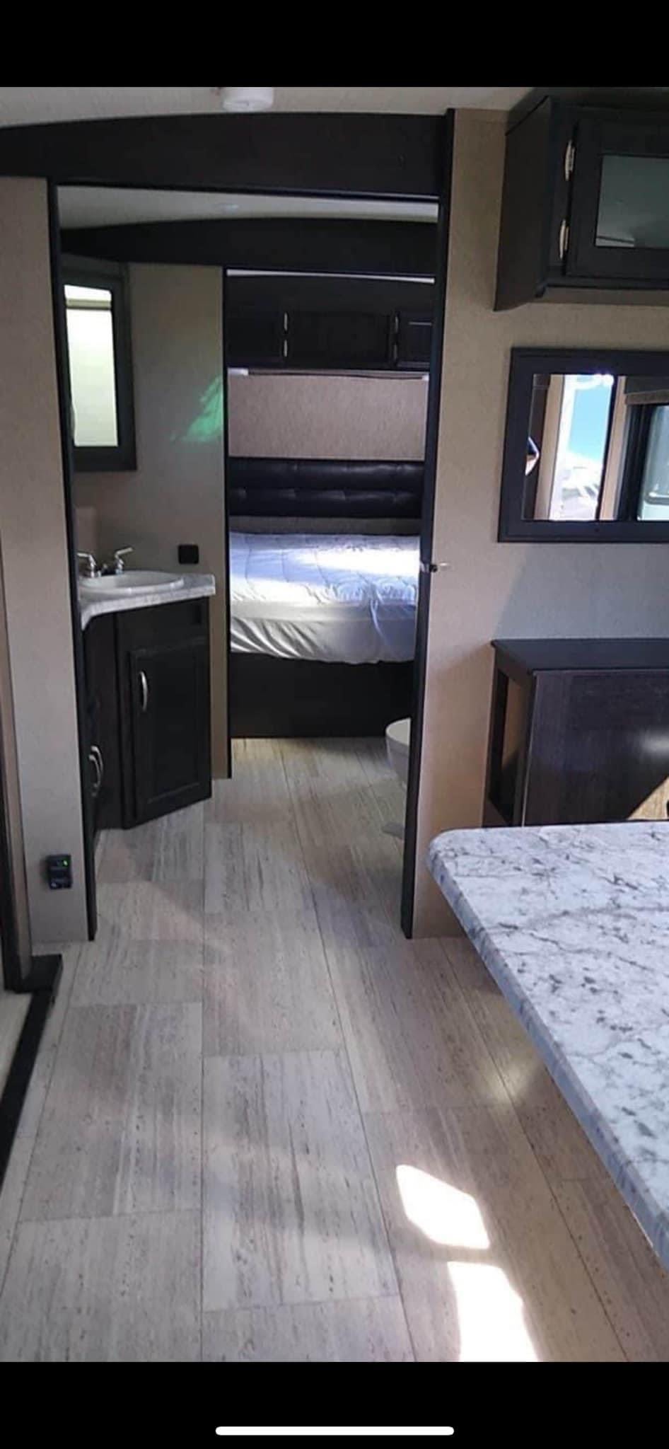 Experience comfort in this RV rental! Features a spacious interior, leading to a private bedroom, bathroom, and a bright living area.. Grand Design Imagine 2018