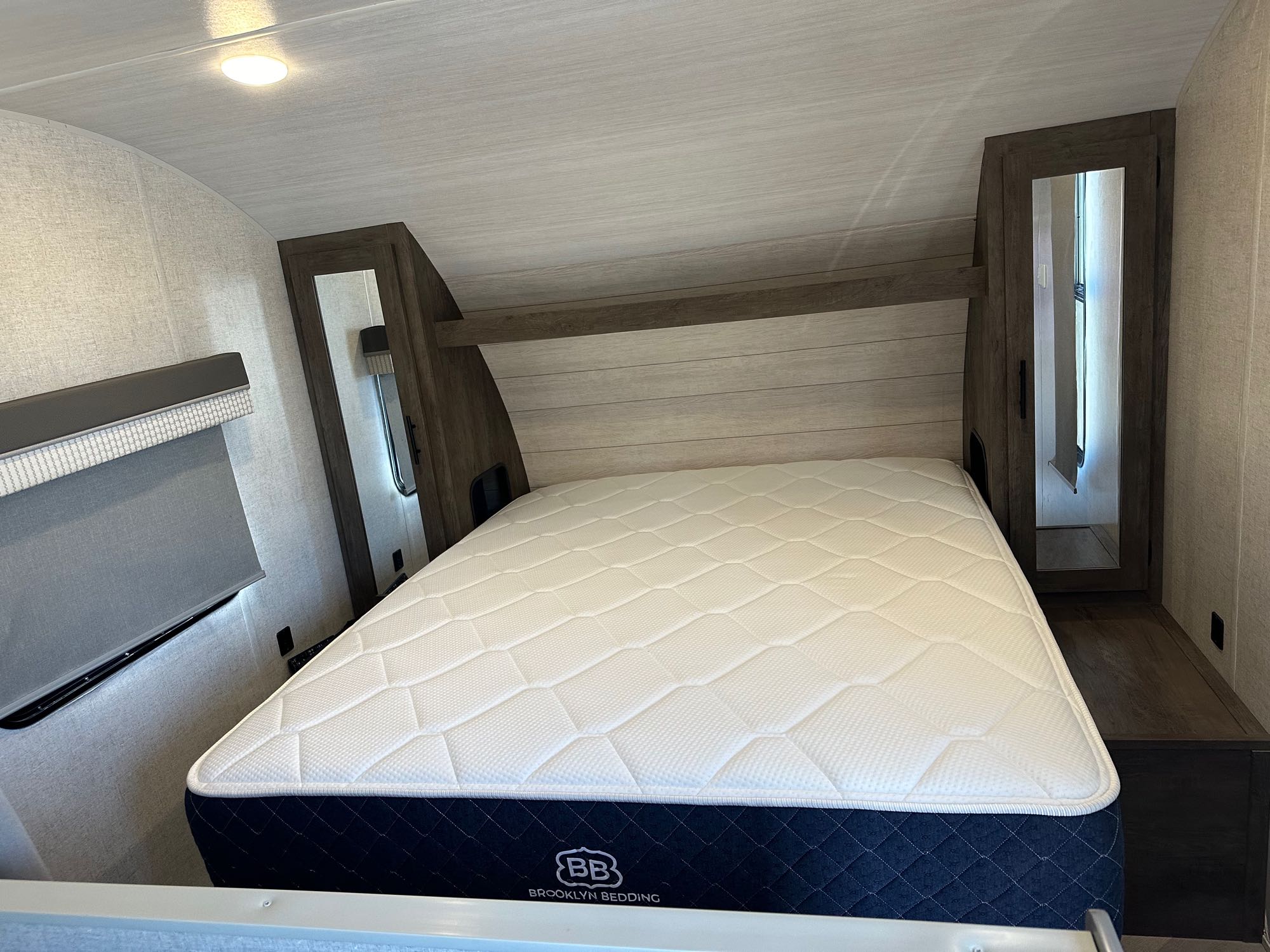 Cozy RV rental bedroom with a comfy mattress, overhead storage, and bright interior lighting.. Forest River Salem Cruise Lite 2021