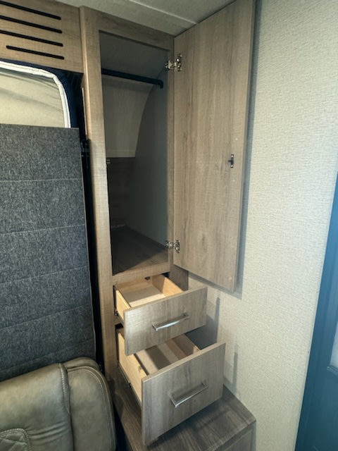 RV rental interior: open wardrobe with hanging rod and two drawers for essential storage.. Grand Design Imagine XLS 2022