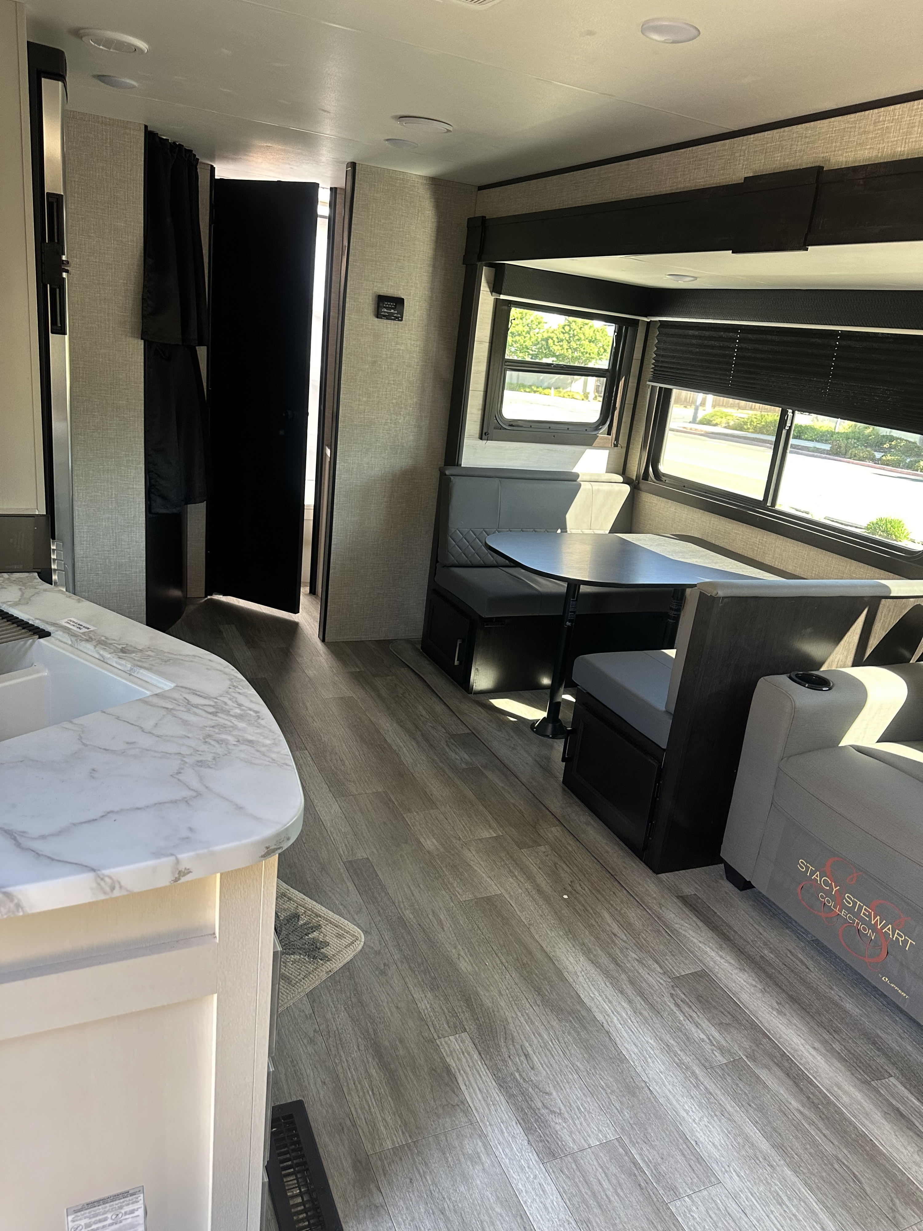 Spacious RV rental interior with kitchen, dinette, and lounge area, featuring modern finishes.. Jayco Jay Flight 2023