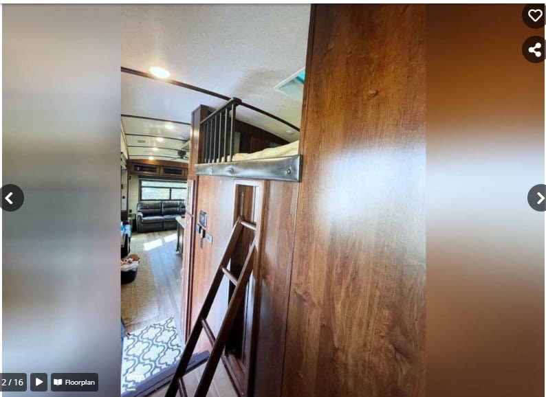 RV rental interior: A cozy loft bunk with ladder, overlooking the living area with sofa and windows.. Jayco Pinnacle 2018