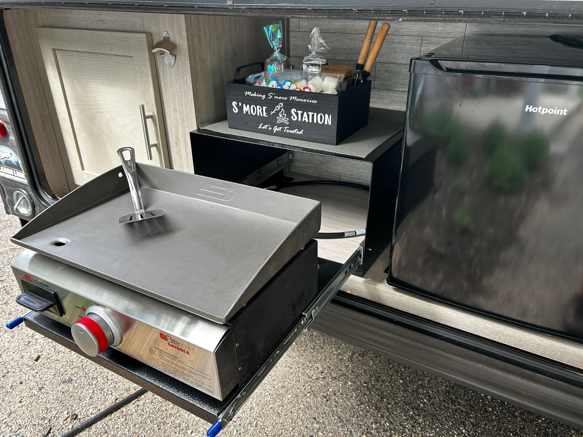 This RV rental features a convenient outdoor kitchen setup, complete with a pull-out griddle, mini-fridge, and a S'more Station for easy camping fun.. Coachmen Catalina 2024