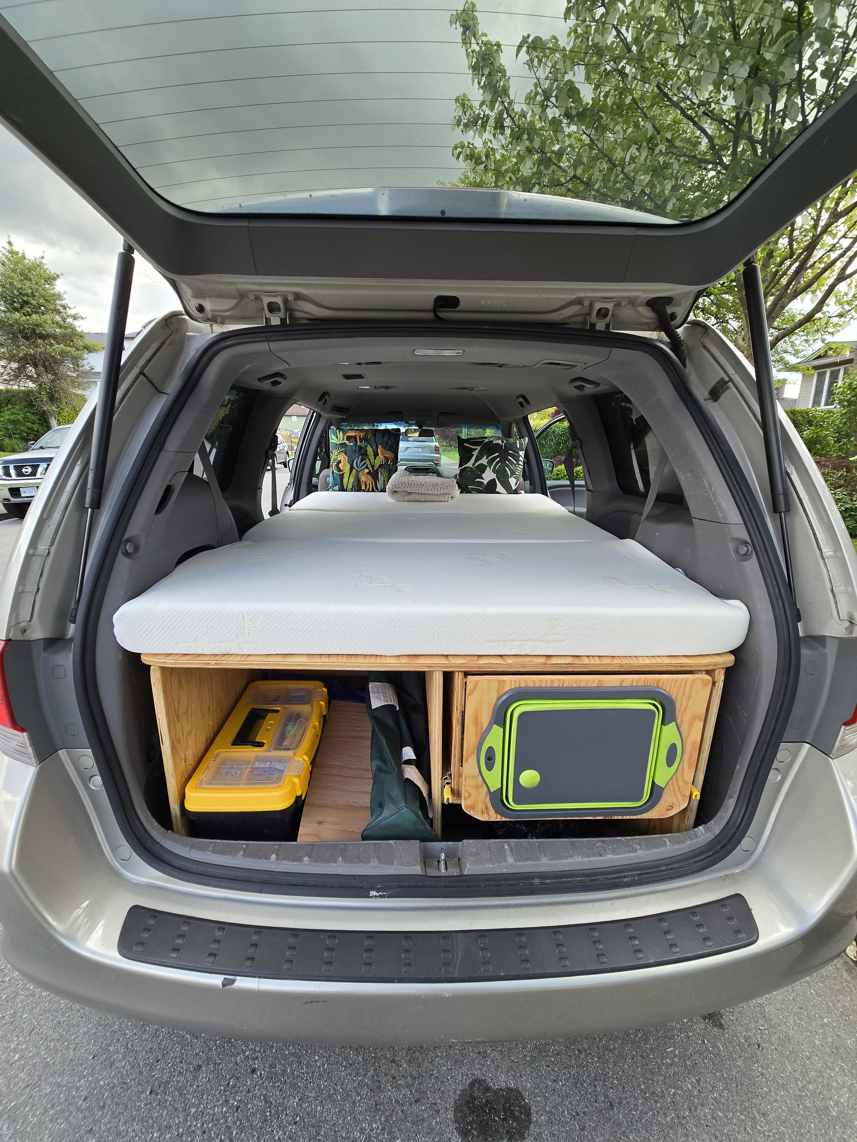 Minivan car camping setup: a comfy mattress over custom storage in the rear. Perfect for an #rvrental alternative.. Honda Odyssey 2008