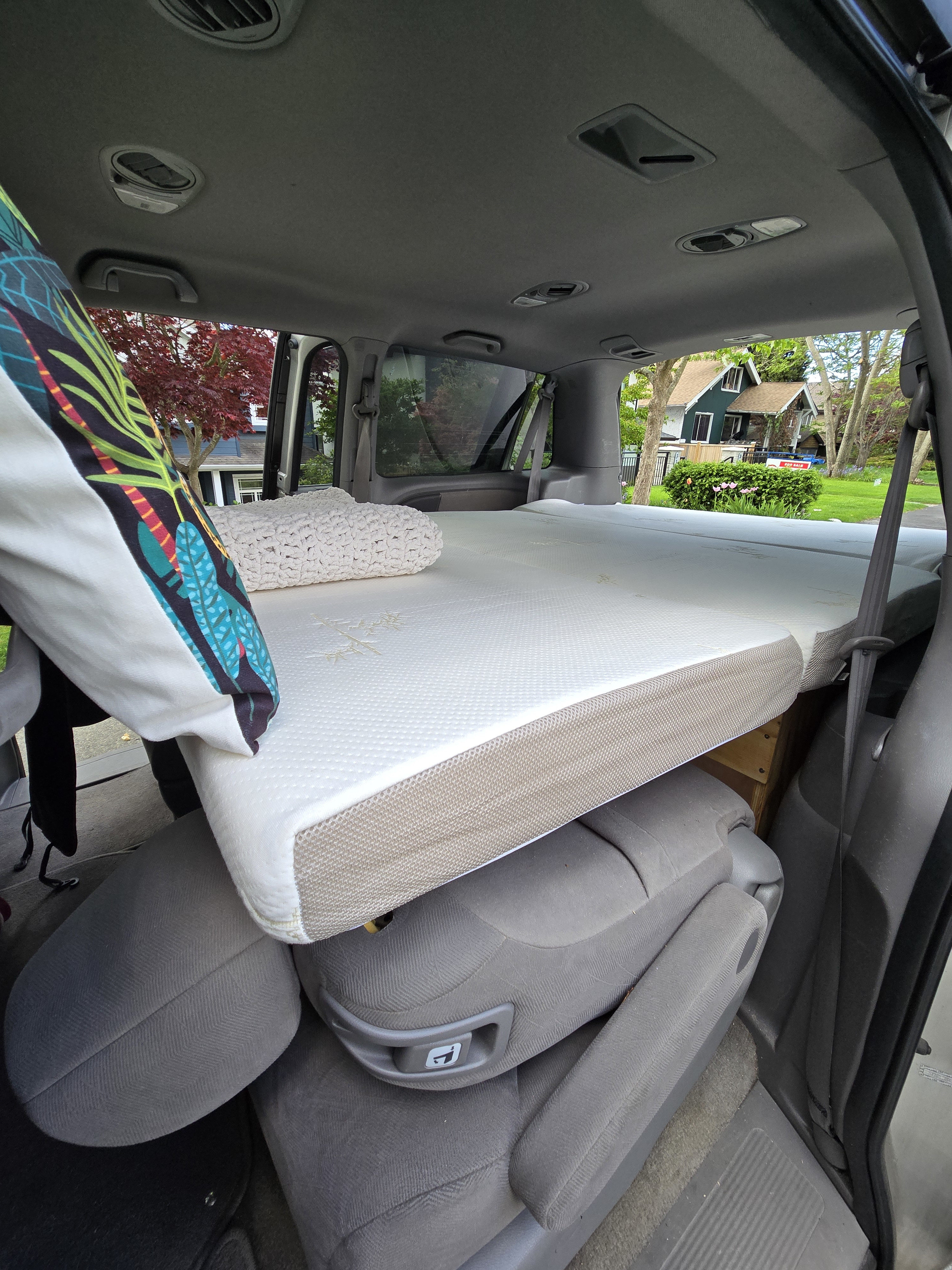 Converted vehicle interior with a comfortable mattress, ideal for car camping or as an RV rental sleeping setup.. Honda Odyssey 2008