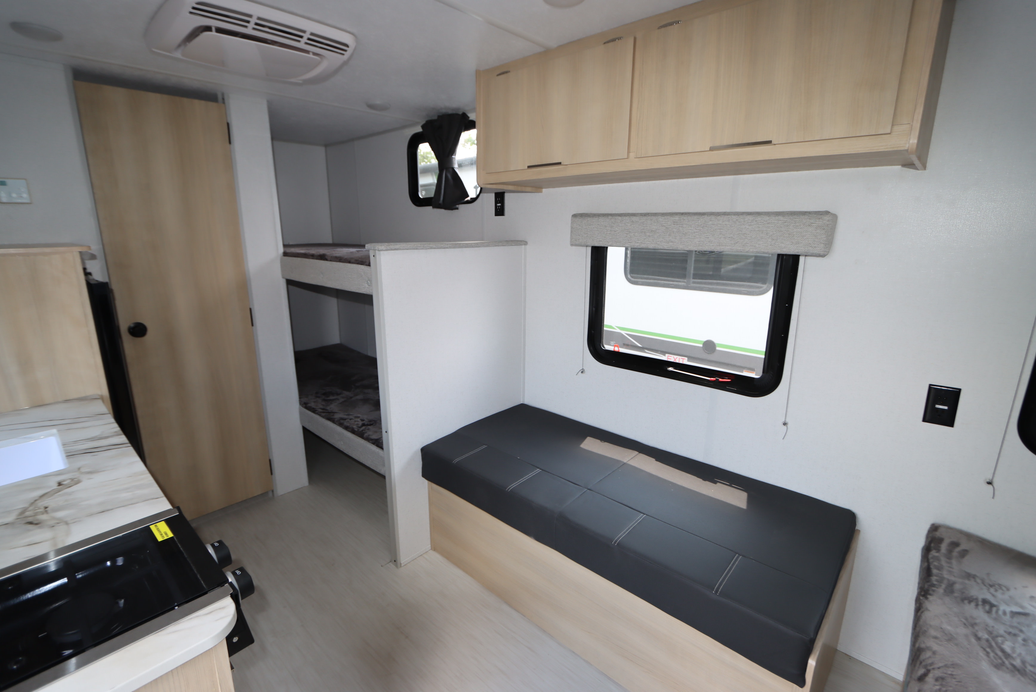 RV rental interior: modern camper with bunk beds, dinette, and kitchen, designed for comfortable travel.. Forest River Salem 2024