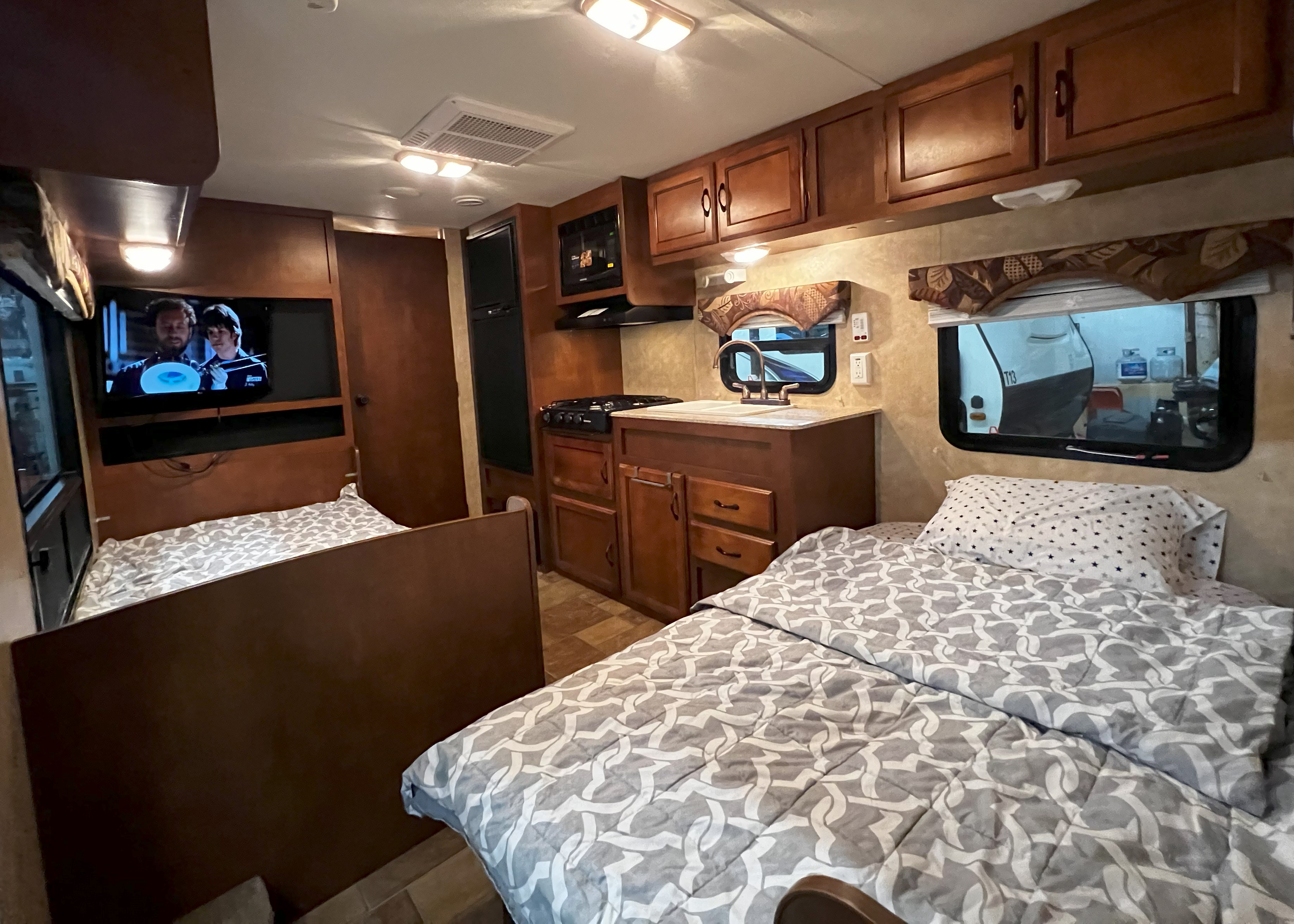 Spacious RV rental interior featuring two comfortable beds, a full kitchen, and entertainment for your travels.. Coachmen Catalina 2012
