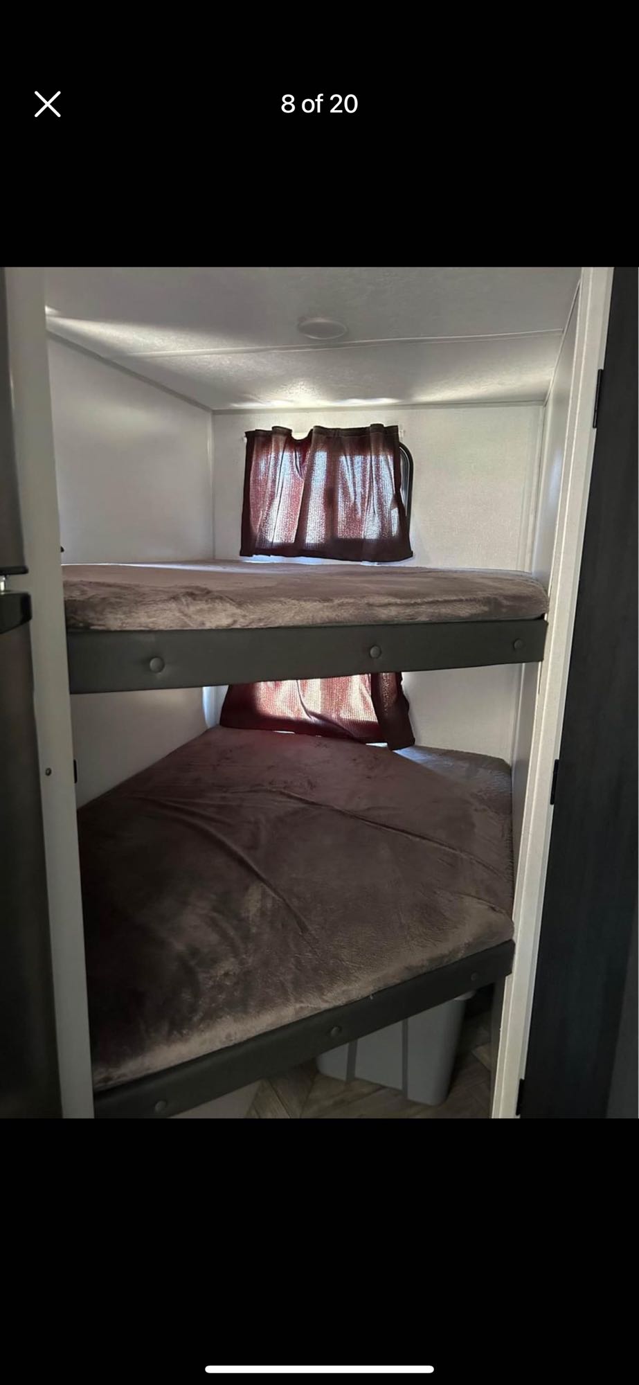 Inside this RV rental: stacked bunk beds with soft blankets and curtains, ideal for family travel.. Forest River Salem FSX 2022
