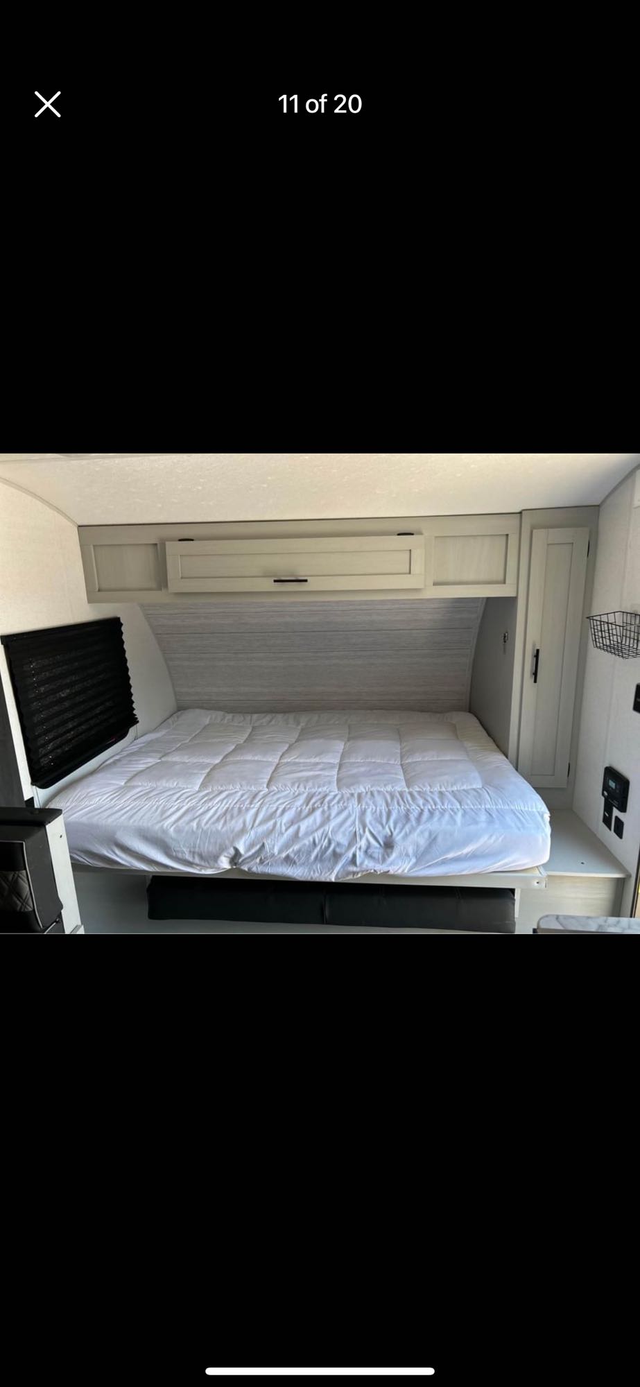 Inside this RV rental: a bright, clean bedroom featuring a comfortable bed and ample overhead storage.. Forest River Salem FSX 2022