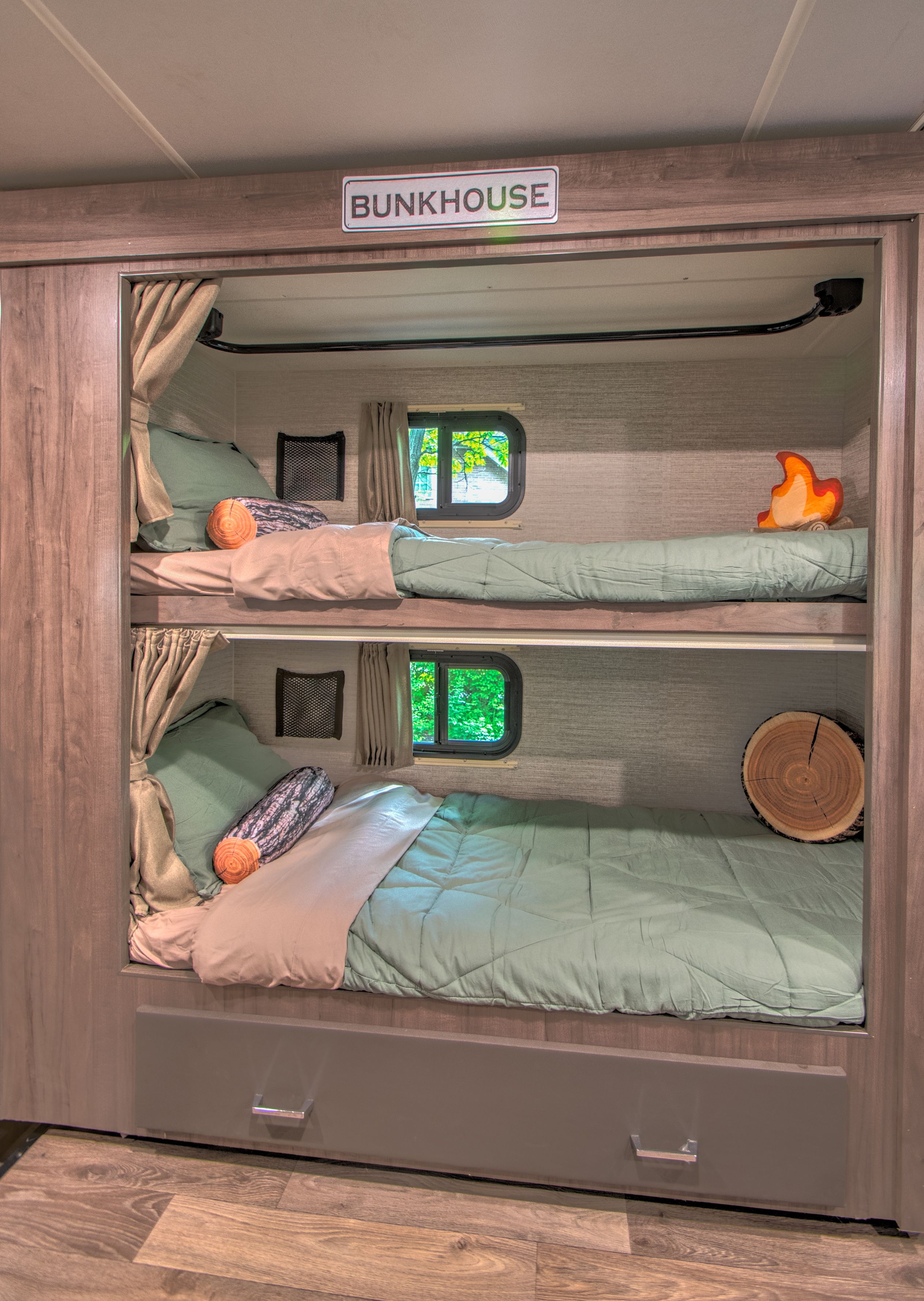 Cozy RV rental bunkhouse with two beds, nature-themed decor, and window views, perfect for a family trip.. Winnebago Minnie Winnie 2021
