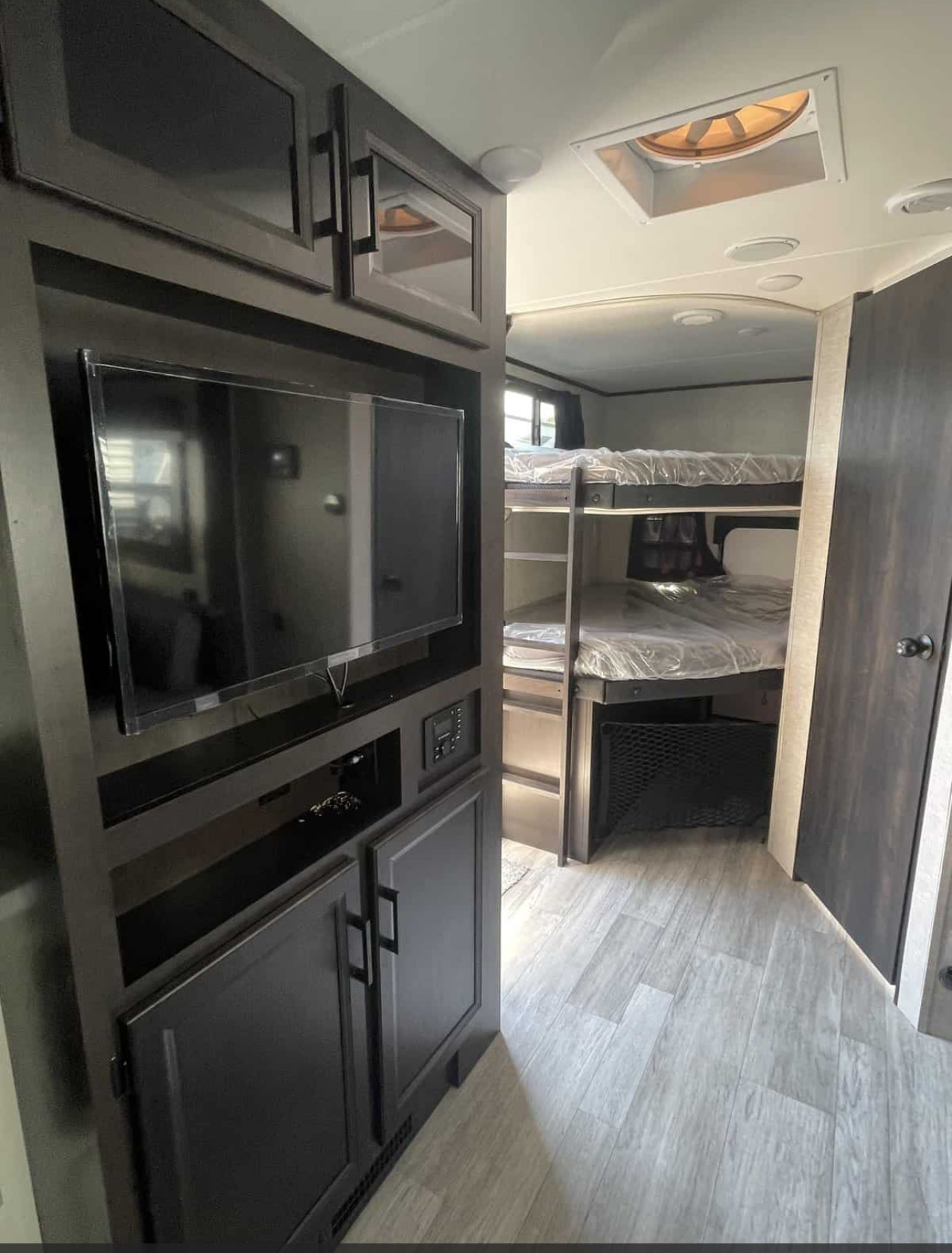 Modern RV rental interior with bunk beds & entertainment center. Ideal for family travel.. Jayco Jay Feather 2022