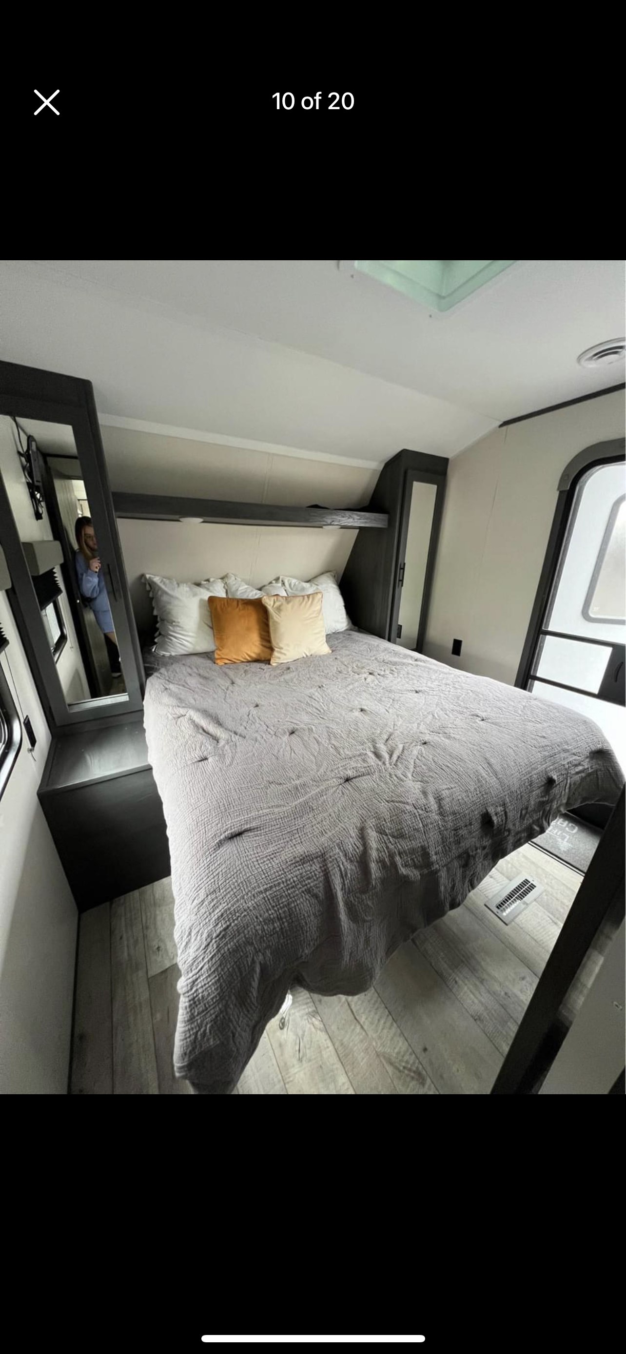 RV rental: Bright bedroom interior with gray bedding, accent pillows, wood floors, & built-in storage for your journey.. Colorado Colorado Trailer 2022