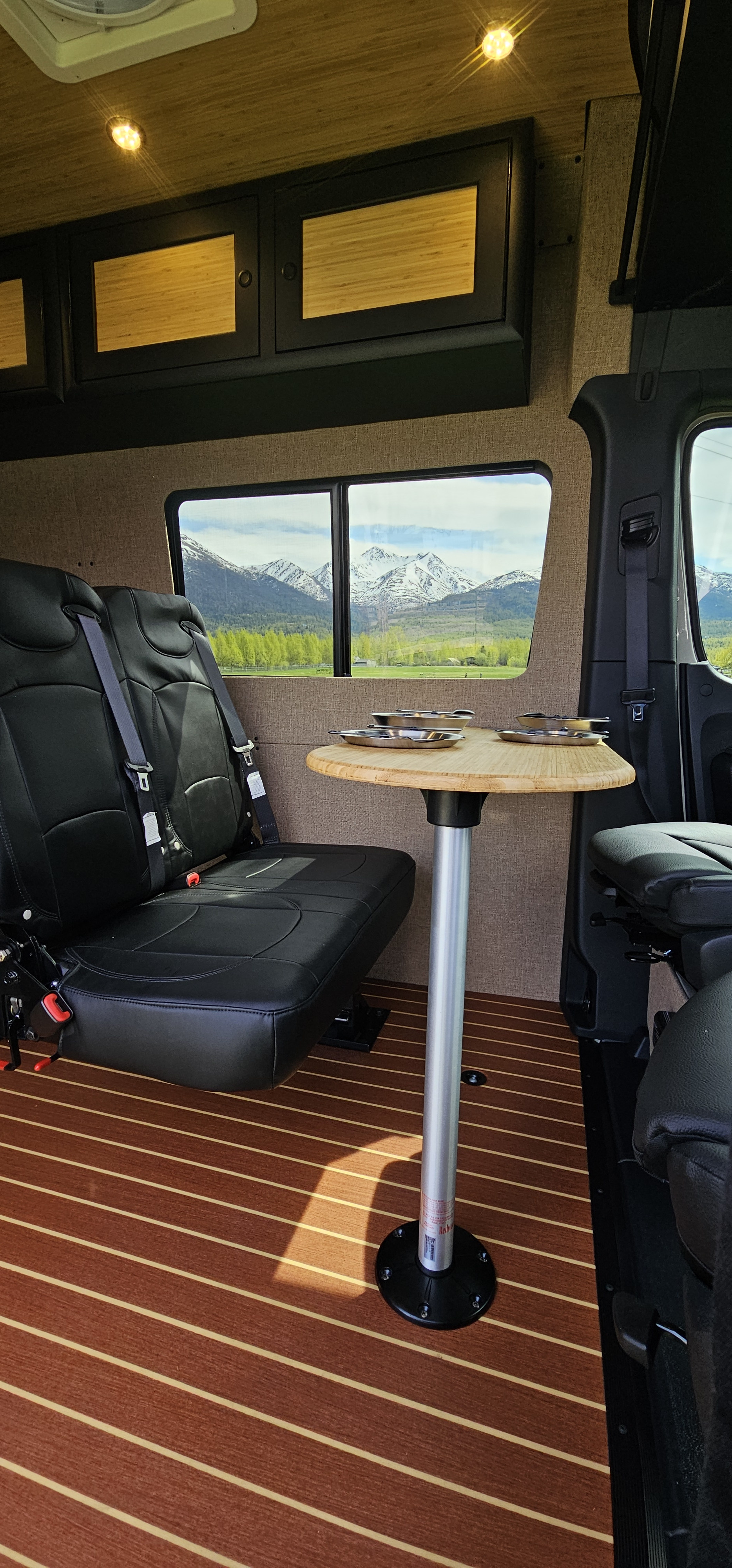 Spacious rv rental with cozy leather seating, wood table, and built-in cabinets. Enjoy stunning mountain views from this camper van.. Mercedes-Benz Sprinter RV Motorhome Campervan 2023