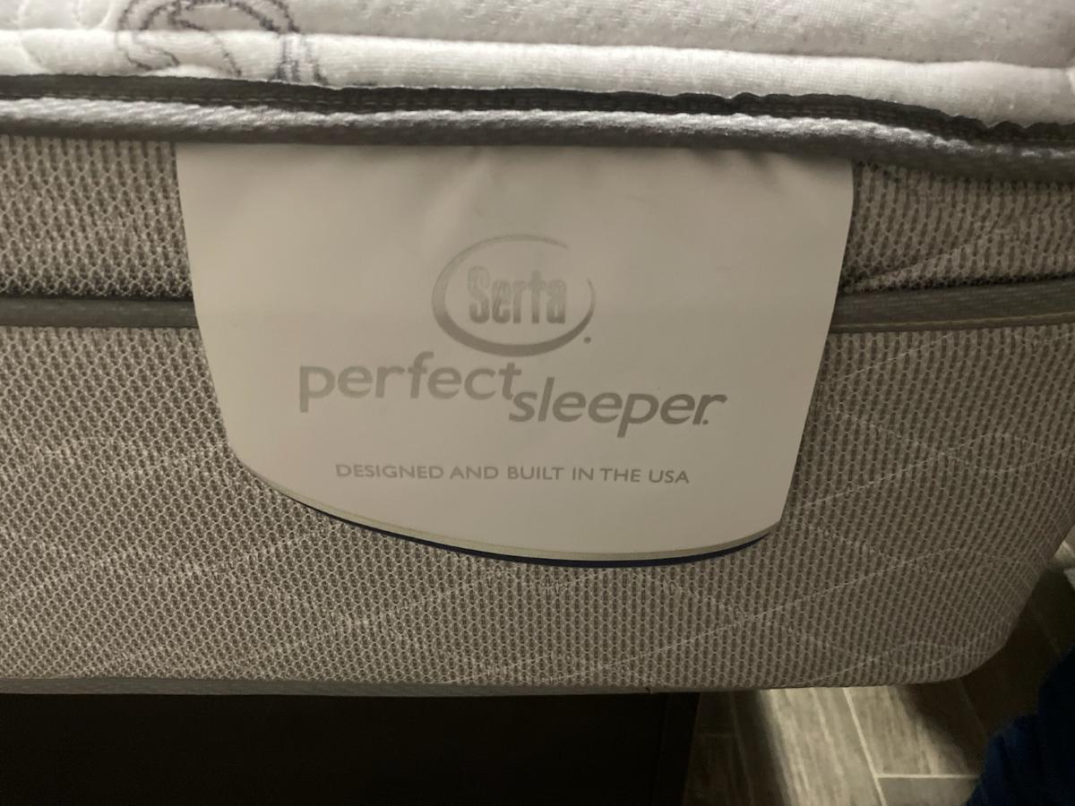 Close-up of a Serta Perfect Sleeper mattress label, USA-built, ideal for your RV rental comfort.. Forest River Palomino Puma 2019