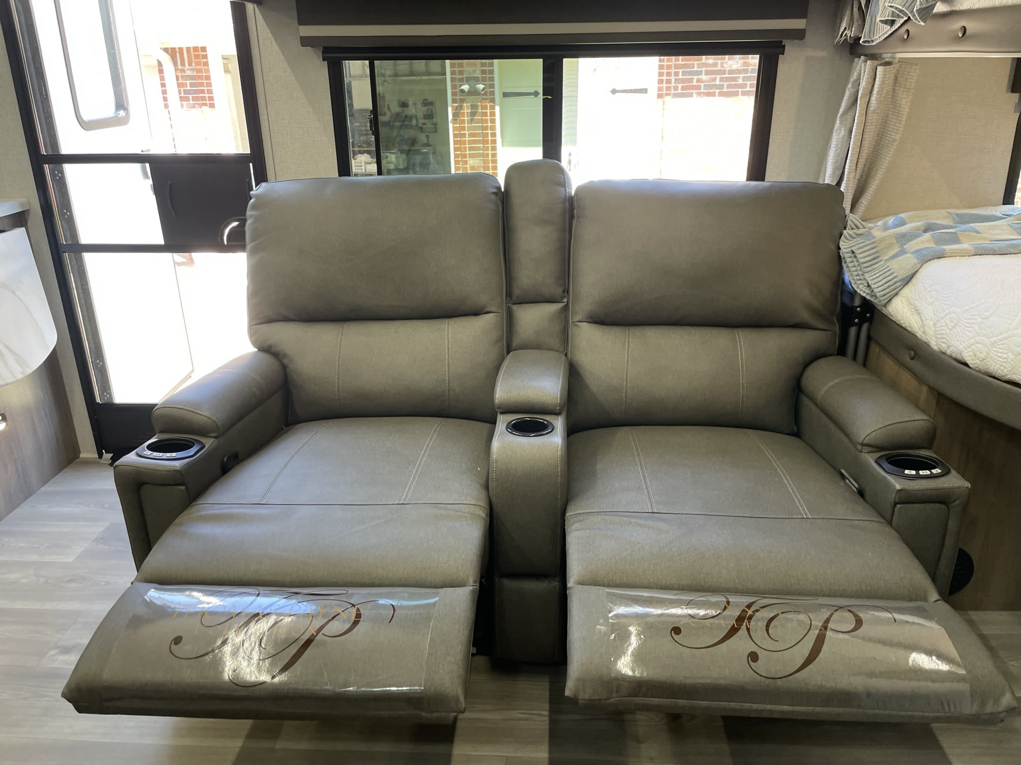 RV rental features cozy theater recliners with cupholders and extended footrests, perfect for a comfortable trip.. Grand Design Imagine XLS 2024