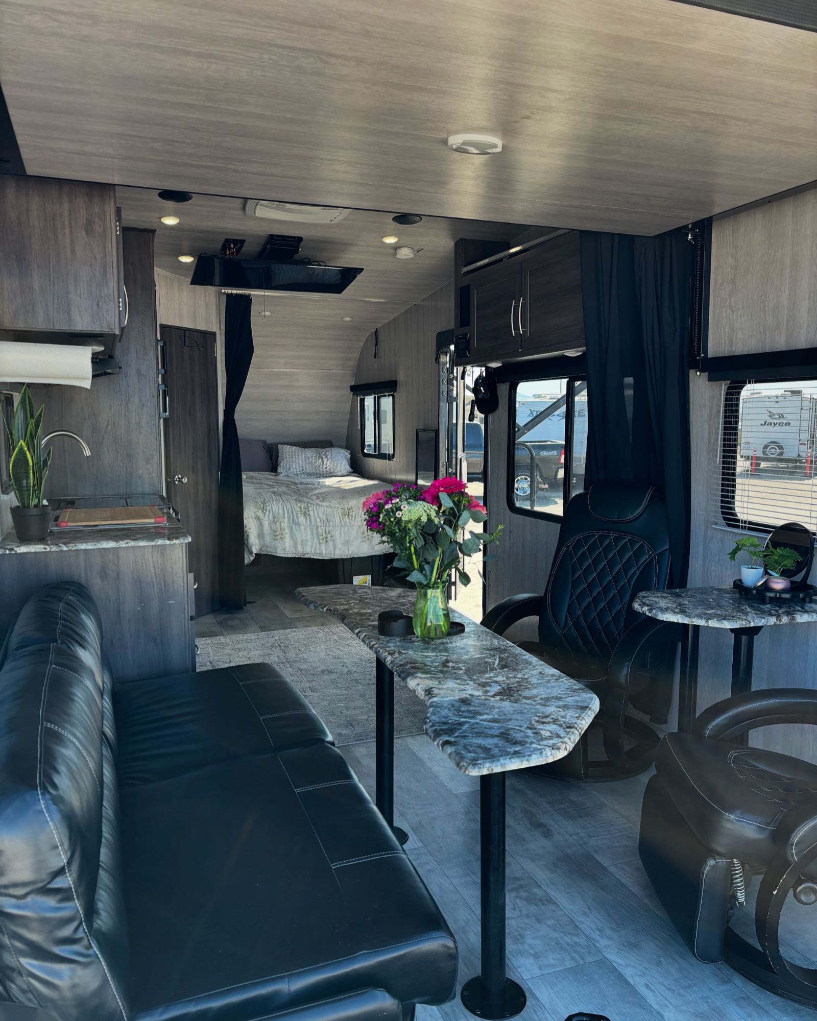 Spacious RV rental interior with a living area, compact kitchen, and rear bedroom setup.. Genesis Supreme Rv Genesis Supreme 2022