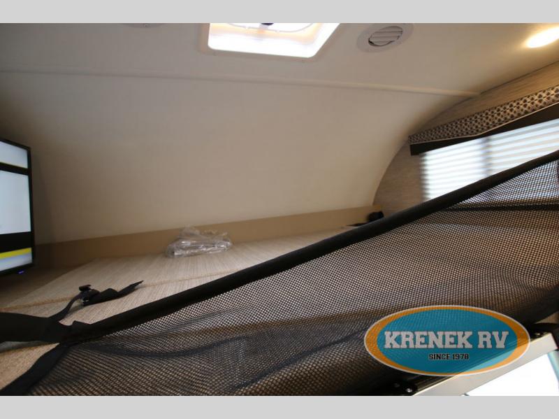 Spacious RV rental cab-over bunk with TV, skylight, and safety net for comfortable sleeping.. Thor Chateau 2022