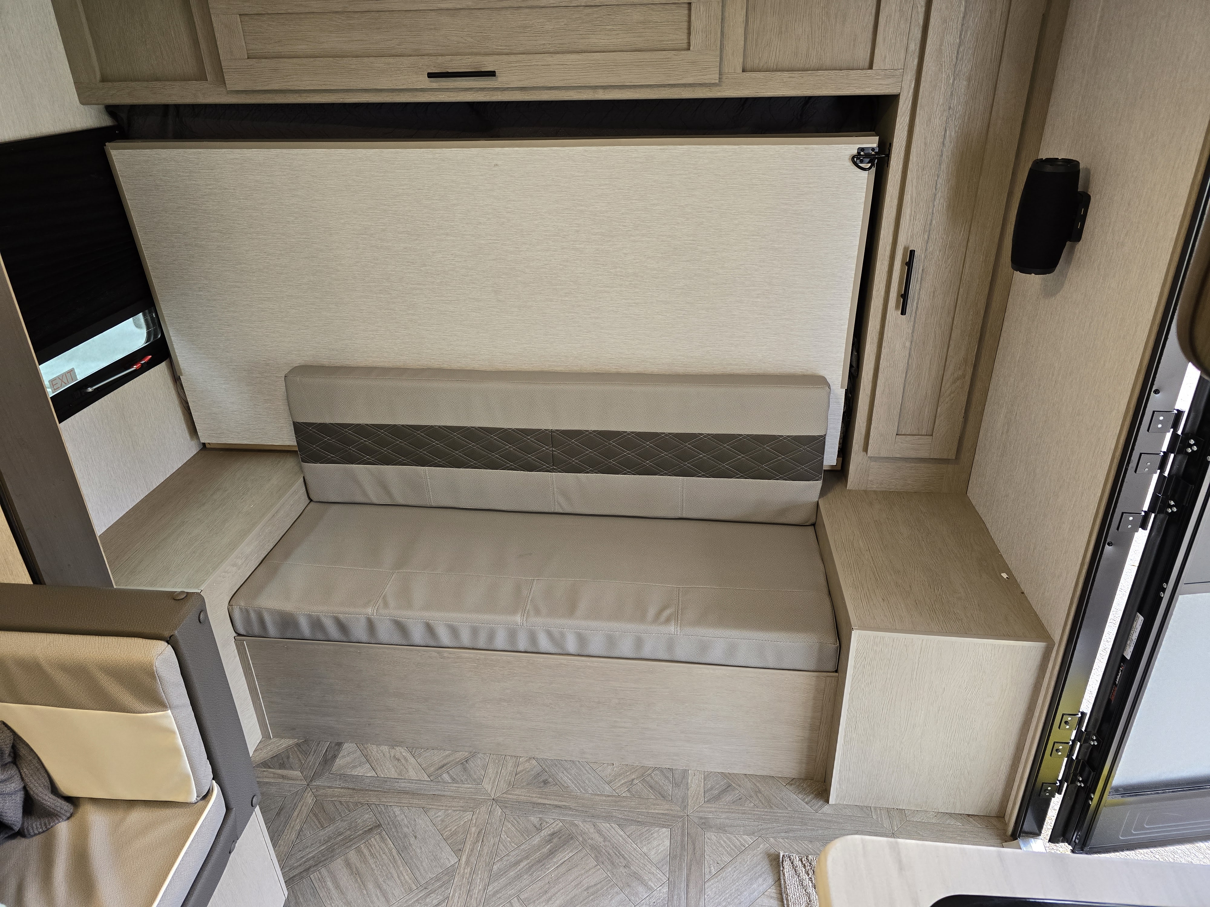 RV rental: Bright interior featuring a grey upholstered bench, wall bed system, light wood cabinets, and geometric flooring.. Forest River Salem FSX 2024