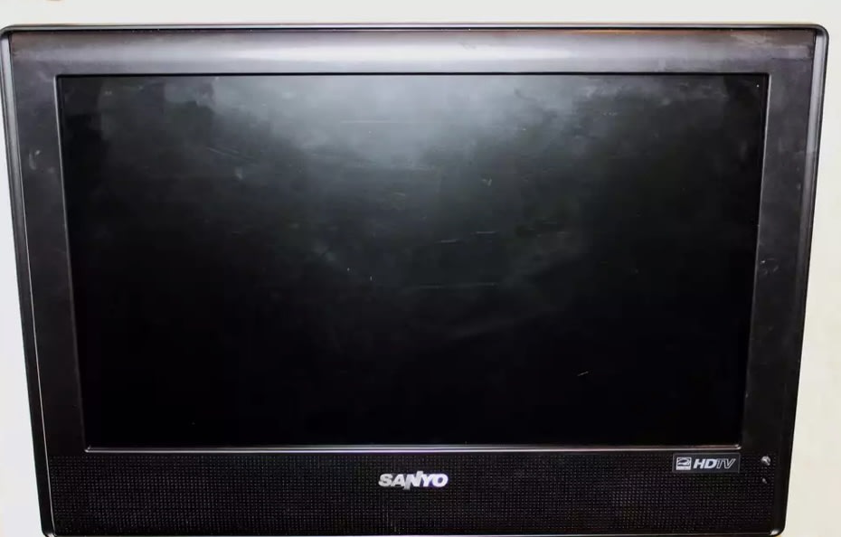 Black Sanyo HDTV with an off screen, showing smudges, ready for an RV rental setup.. Forest River Salem Cruise Lite 2014