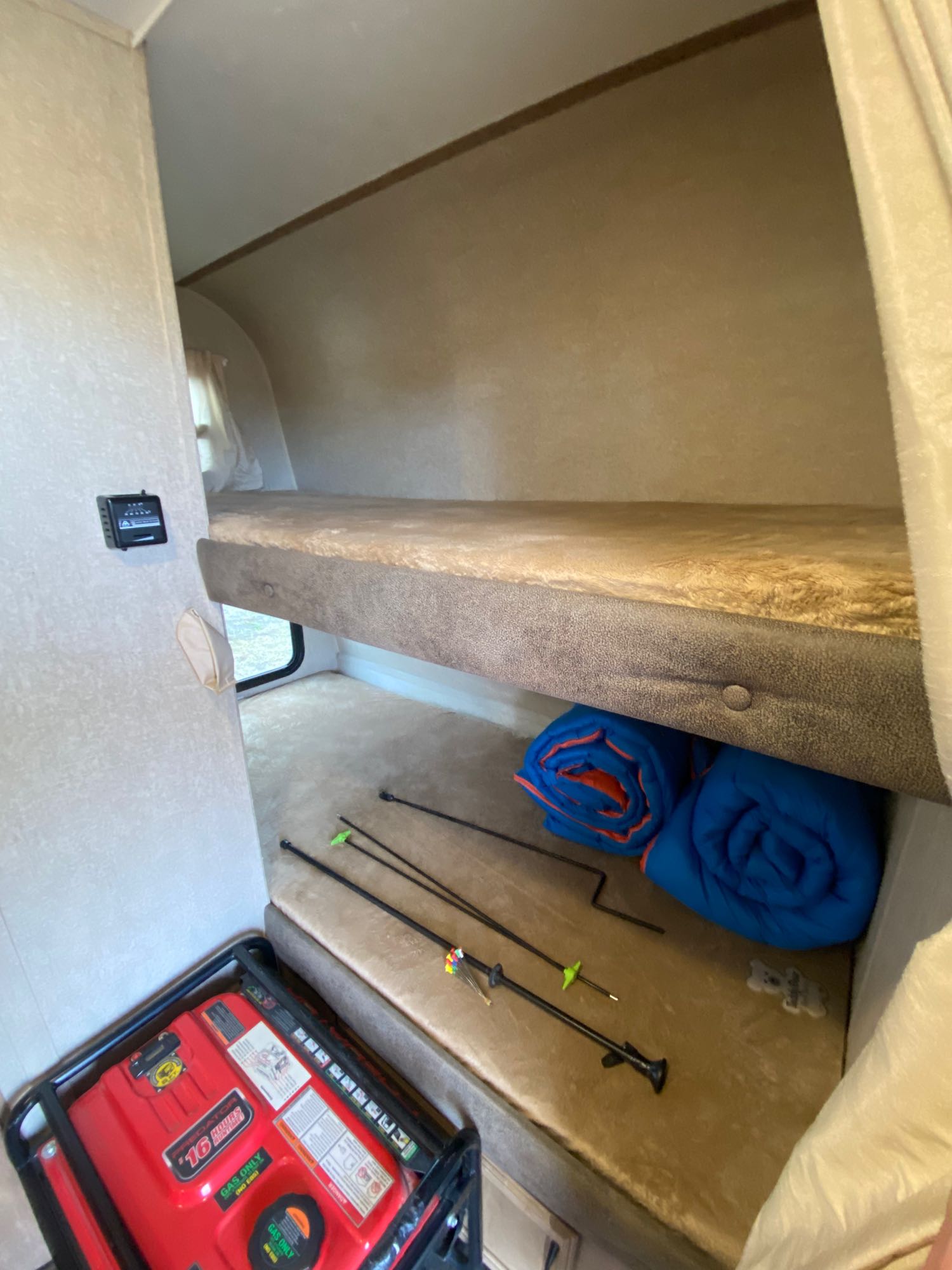 RV rental interior: bunk beds with a generator, sleeping bags, and poles, offering comfort for adventurers.. Starcraft Launch Outfitter Extreme 2018
