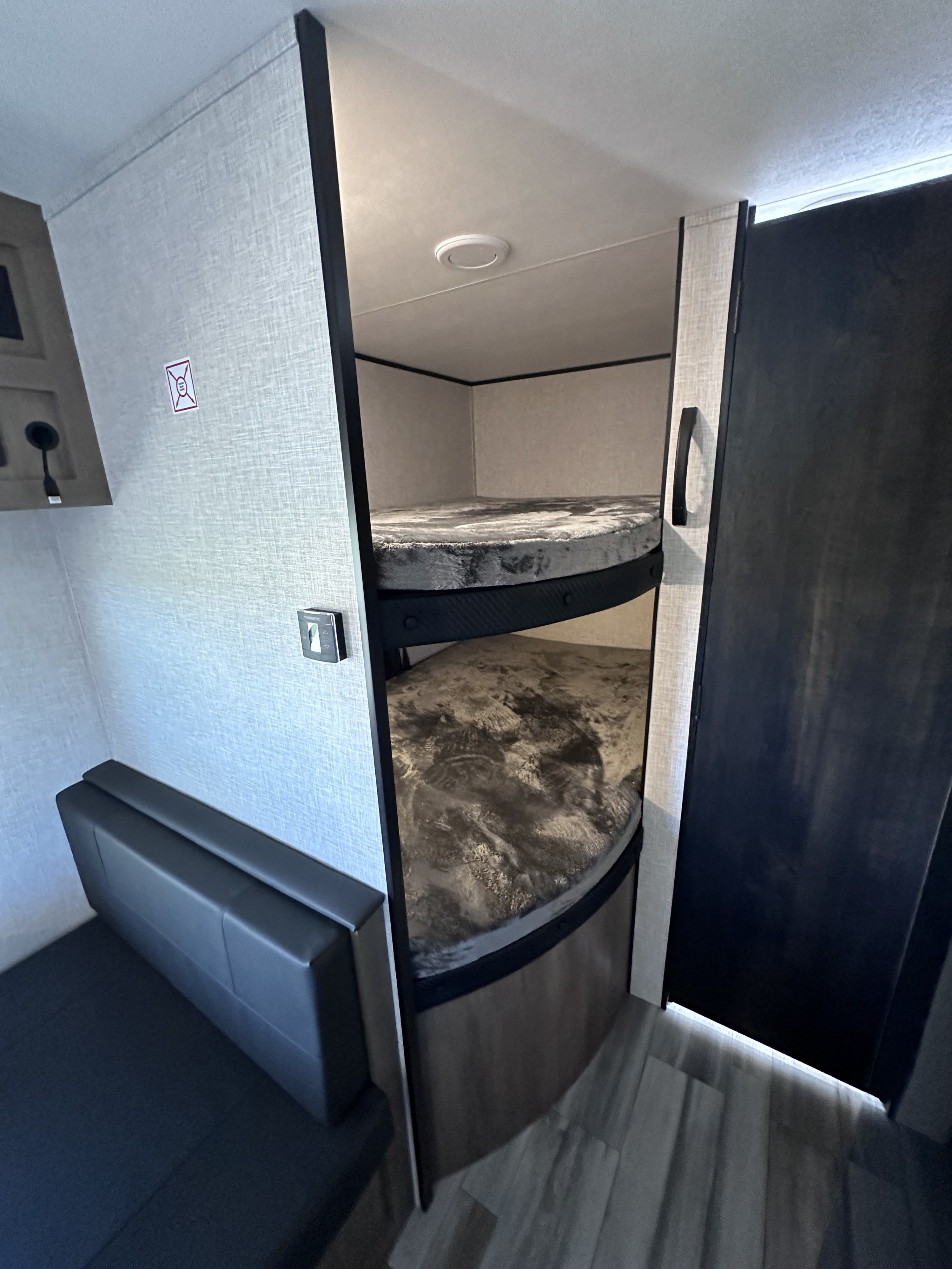 Cozy RV rental interior with comfortable bunk beds and versatile seating, perfect for family adventures.. Jayco Jayflight SLX 260BH 2024