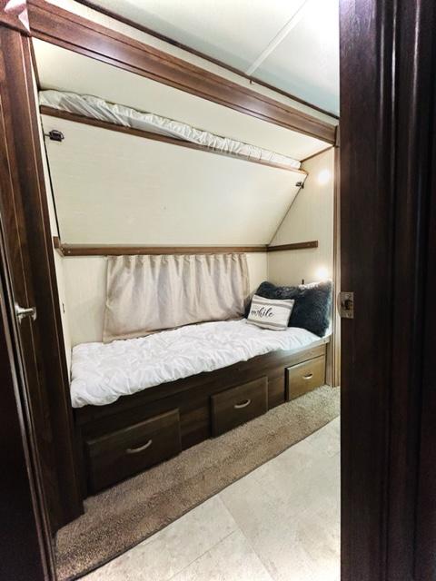 Comfortable RV rental bunk bed area with integrated storage drawers. Ideal for family travel, cozy interior.. Palomino Columbus Castaway 2019