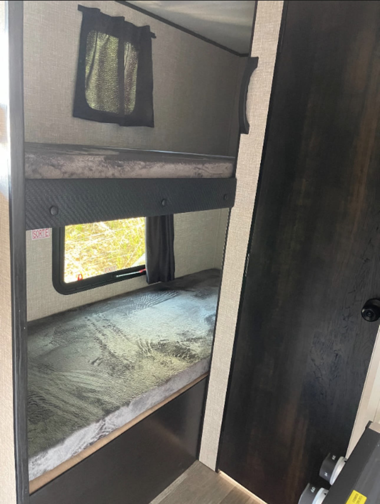 RV rental bunk beds: two cozy sleeping areas with windows and textured grey bedding inside a modern interior.. Jayco Jay Flight SLX 2022