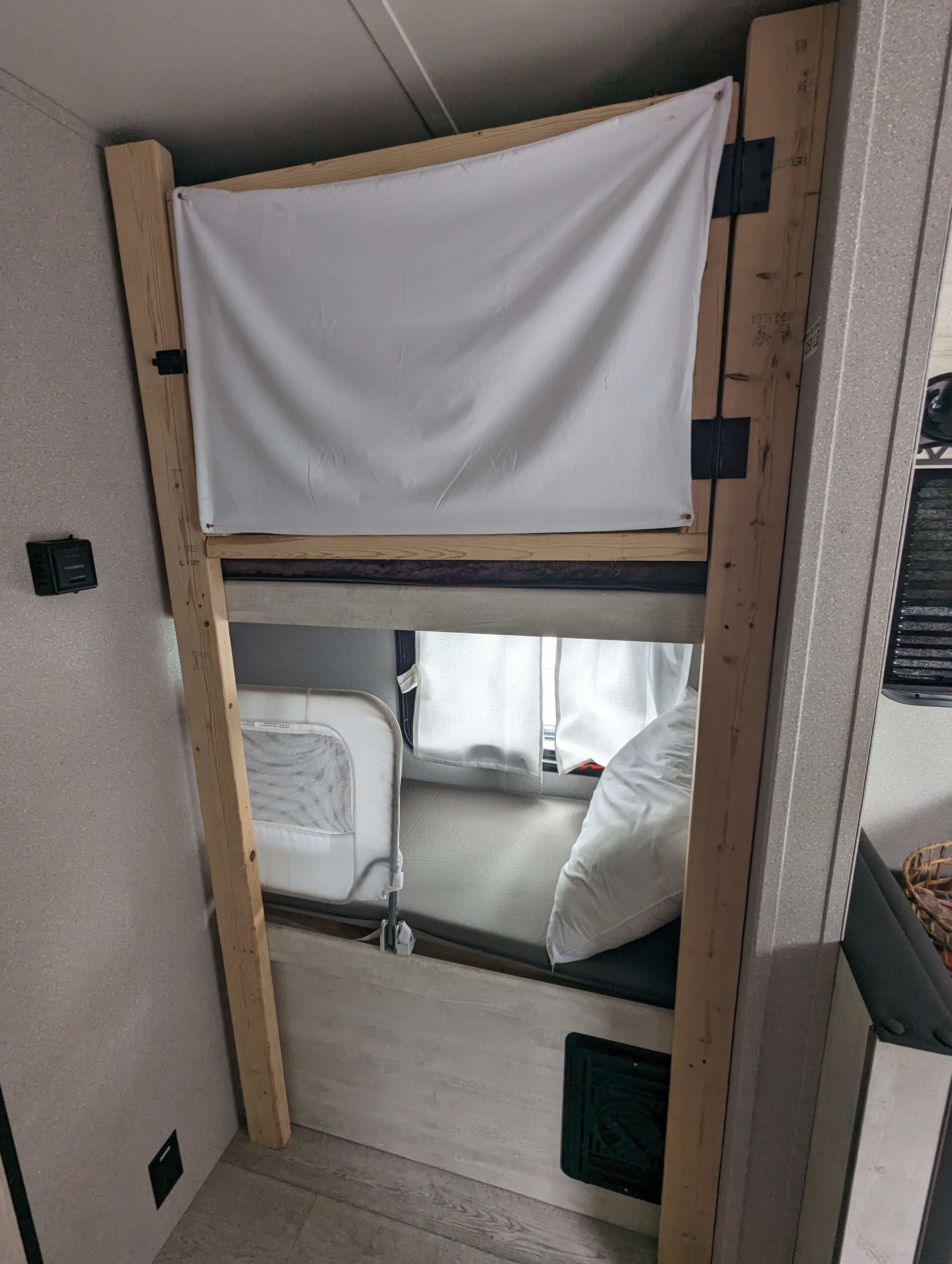 RV rental: Bunk beds with a fabric privacy screen for the top bunk and a child rail for the lower bunk.. Grand River Comfortline 20bh 2022