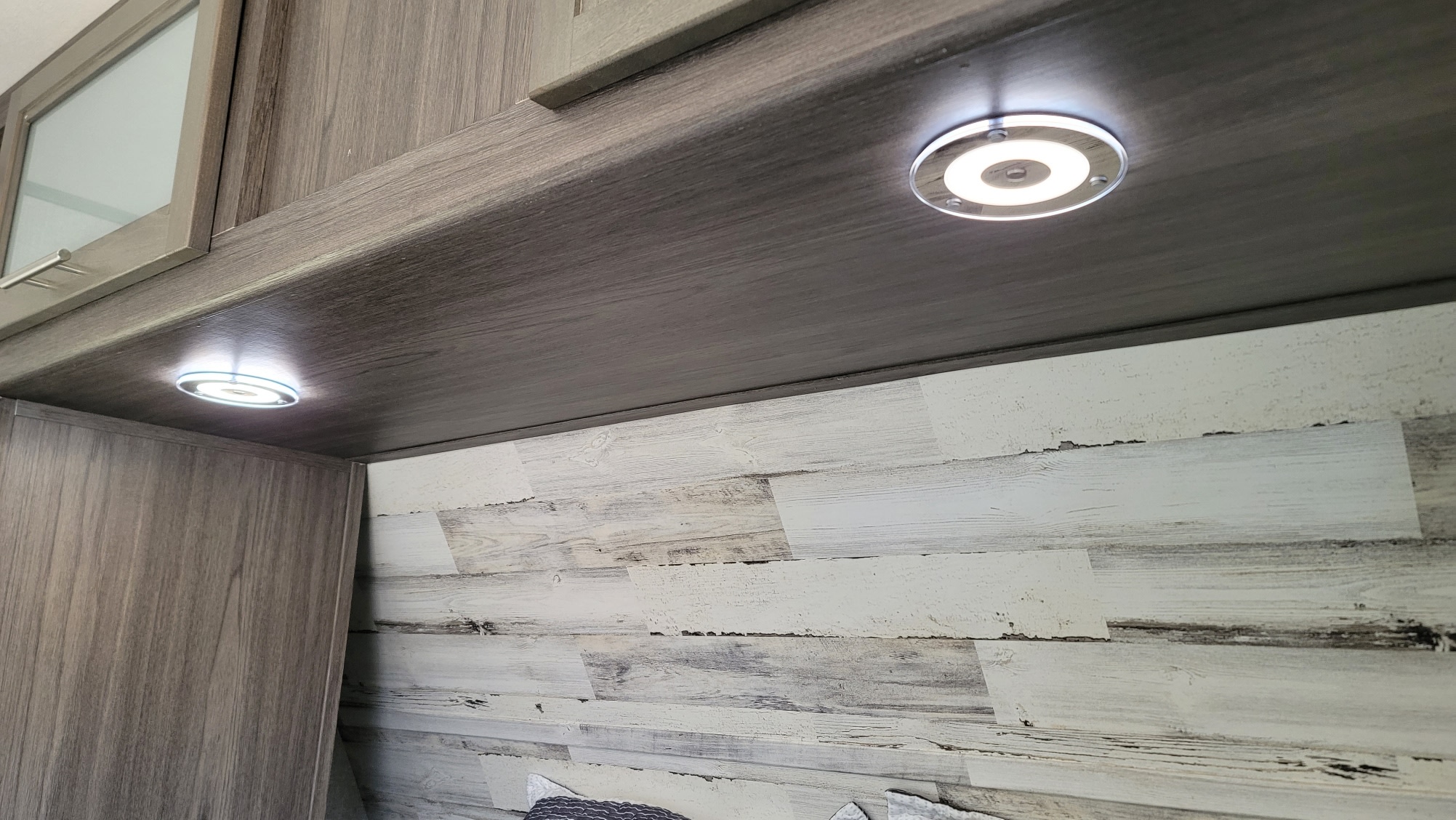 RV rental interior featuring modern under-cabinet lighting, gray wood cabinets, and a whitewashed plank wall.. Dutchmen Kodiak Ultra Lite 2020