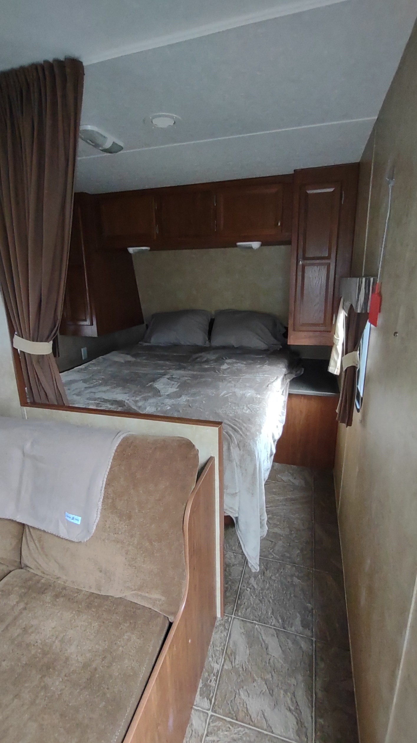 Experience a comfortable RV rental: A compact bedroom with a bed & cabinets, plus a cozy living area with a sofa.. Jayco Jay Flight Swift 2012