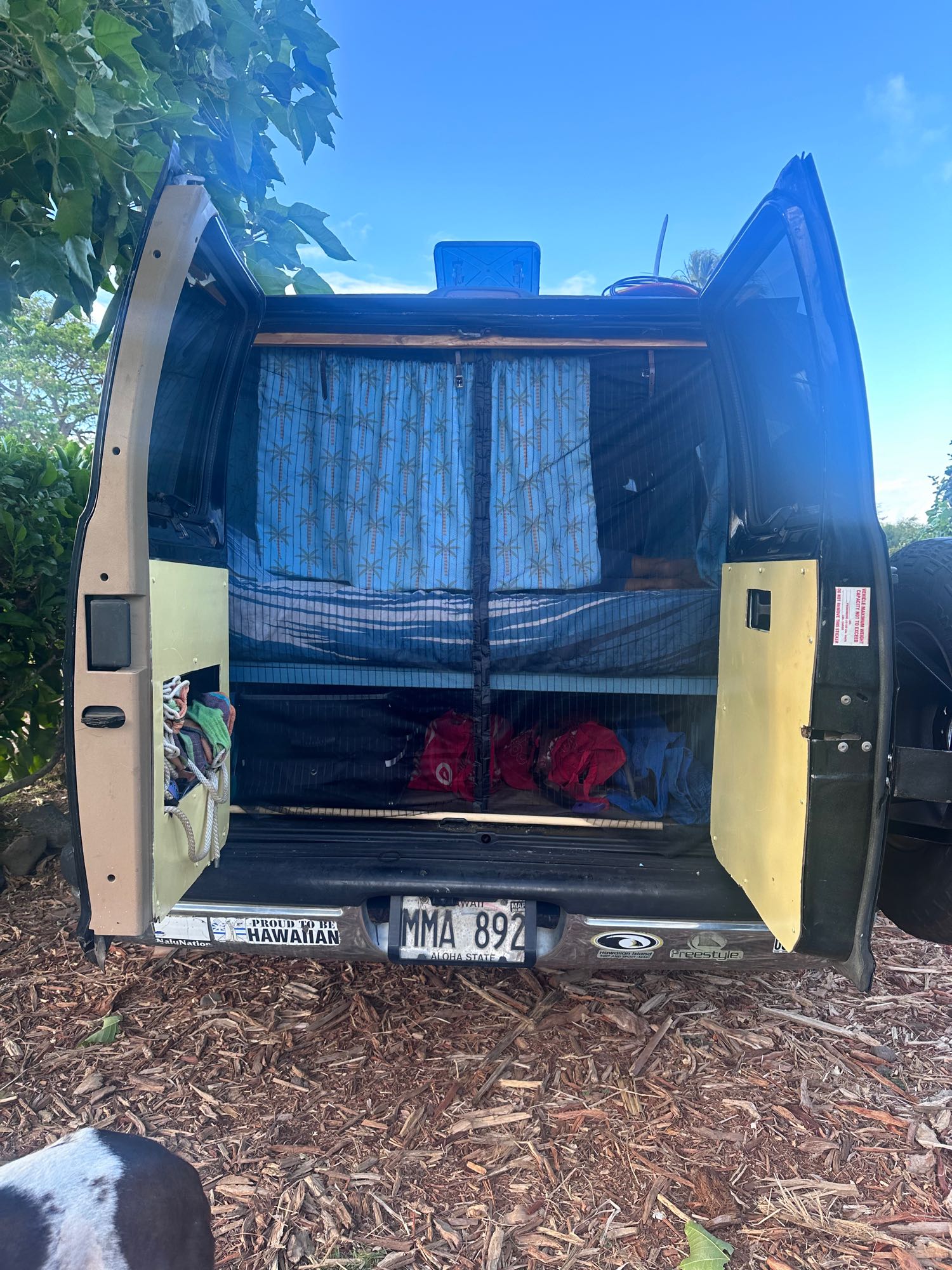 Open rear of a custom Hawaiian camper van, showing a bed & storage. Great "rv rental" option for island adventures.. Dodge 1500 1999