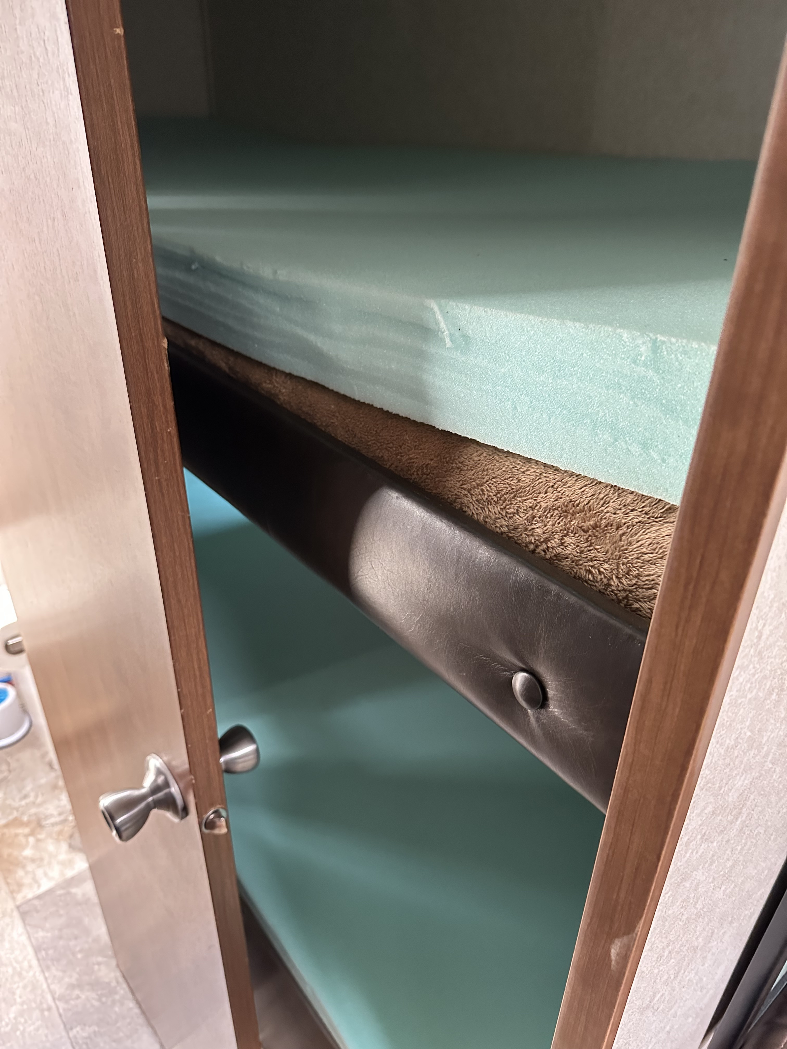 Cozy bunk beds inside an RV rental, featuring light blue foam mattresses and a brown blanket. Perfect for family adventures.. Jayco Jay Flight SLX 2017