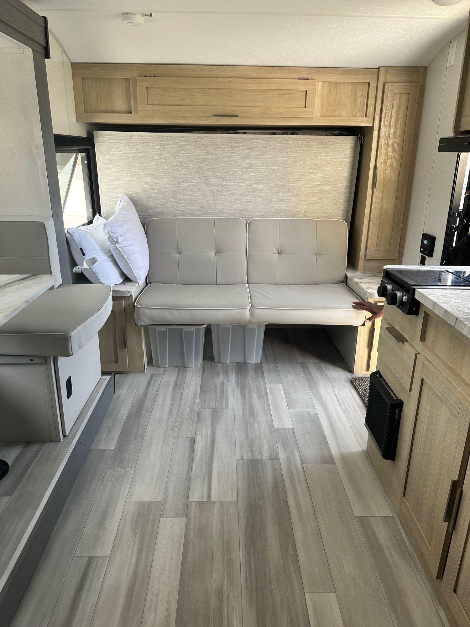 RV rental interior featuring a clever murphy bed setup, dinette, and compact kitchen. Perfect for travel!. Forest River Salem FSX Platinum 2023