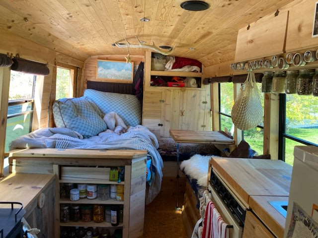 Step inside this custom RV rental, a stunning wood-paneled bus conversion with a comfy bed, kitchen, and clever storage solutions.. GMC Savana 3500 2011