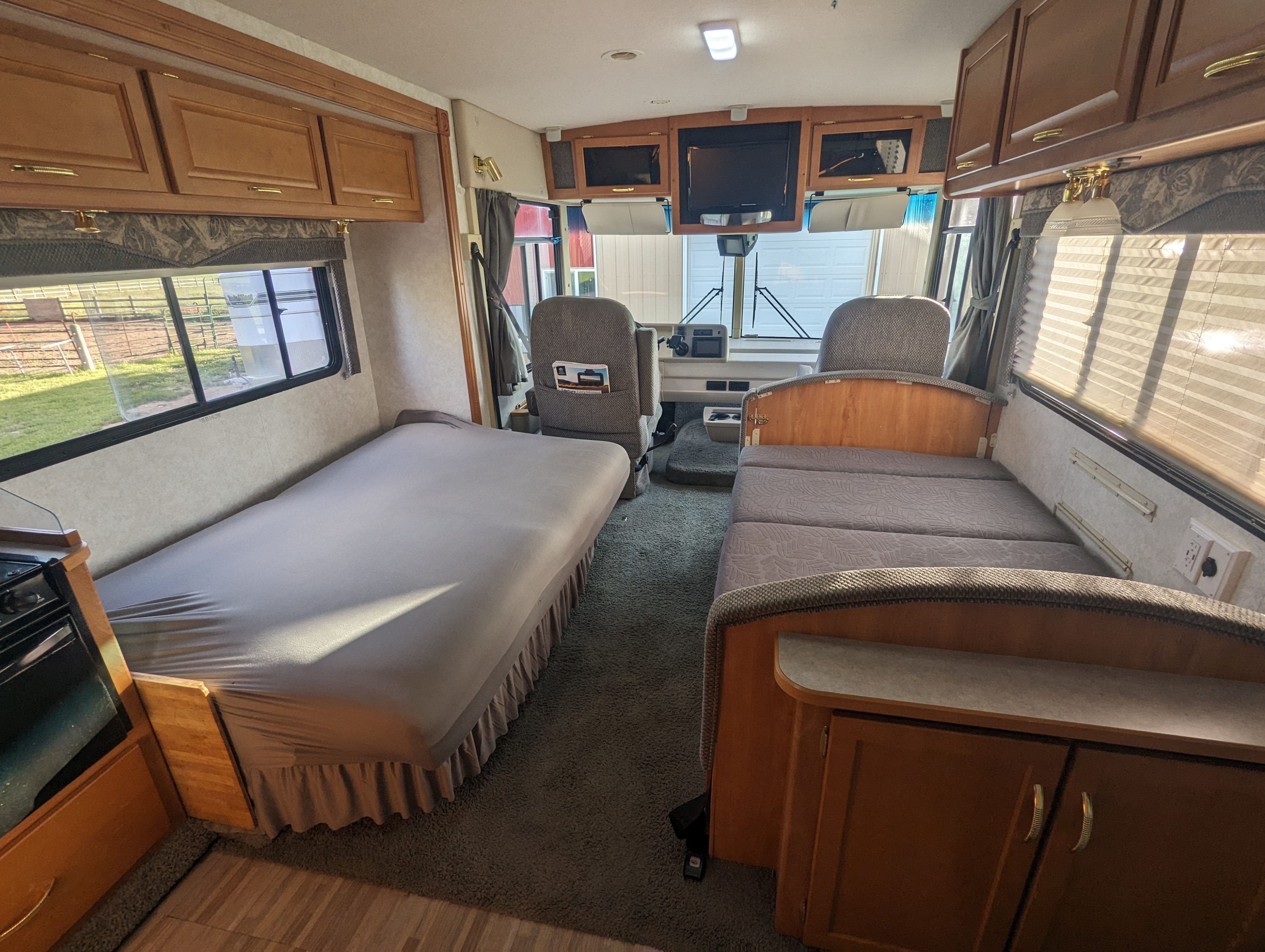 This RV rental's cozy interior features multiple beds, a compact kitchen area, and the front cockpit, ready for your next adventure.. Itasca Sunova 2006