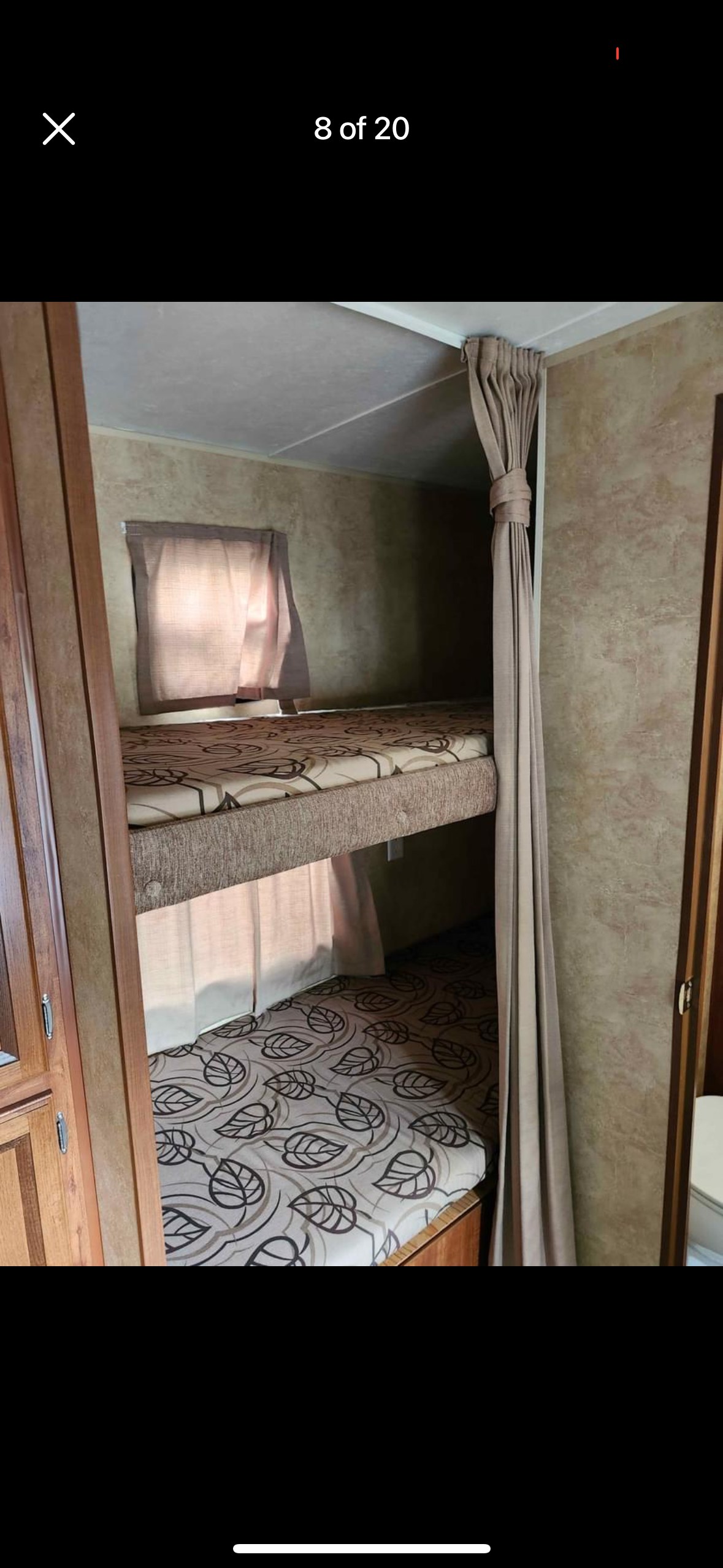 RV rental: Interior bunk beds featuring patterned mattresses, a window, and a tied-back curtain.. Jayco Jay Flight 2012