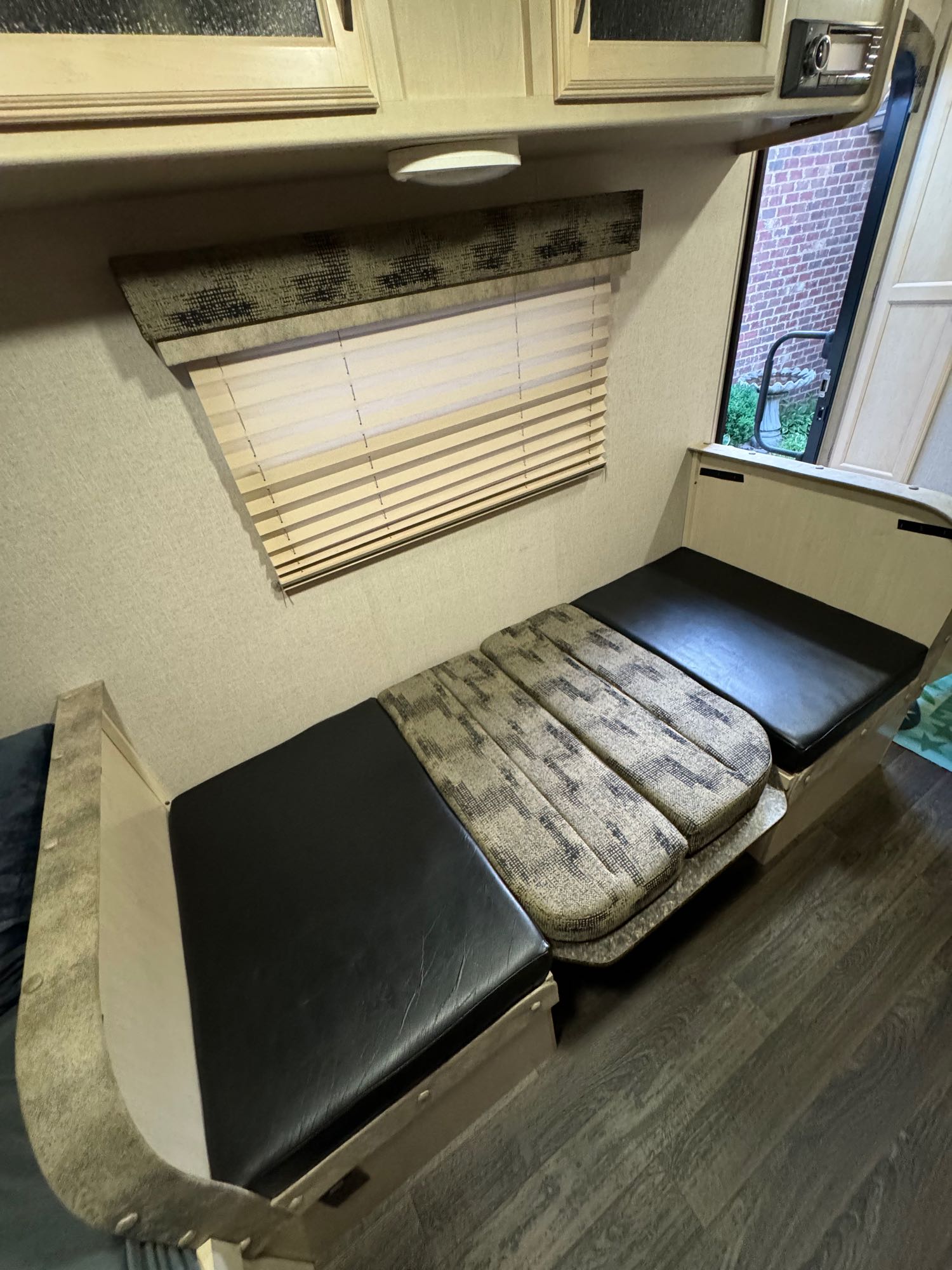Explore this RV rental's versatile interior: a dinette convertible to a bed, with comfortable cushions, window blinds, and cabinets.. Minnie Minnie Drop 2019