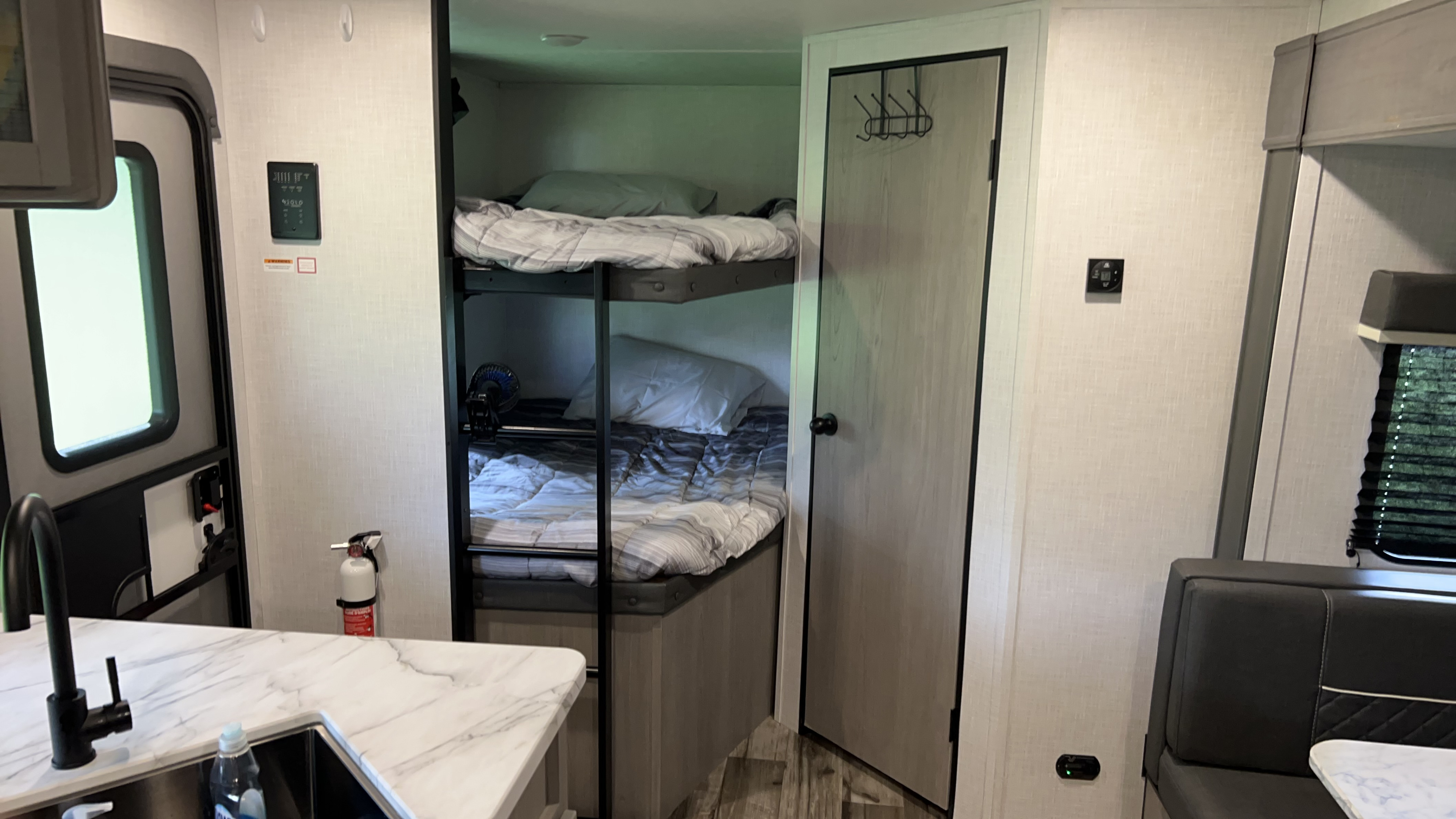 Explore this RV rental's interior: bunk beds, a dinette, and kitchen counter with sink. Ready for your road trip!. Dutchmen Coleman Lantern LT 2022