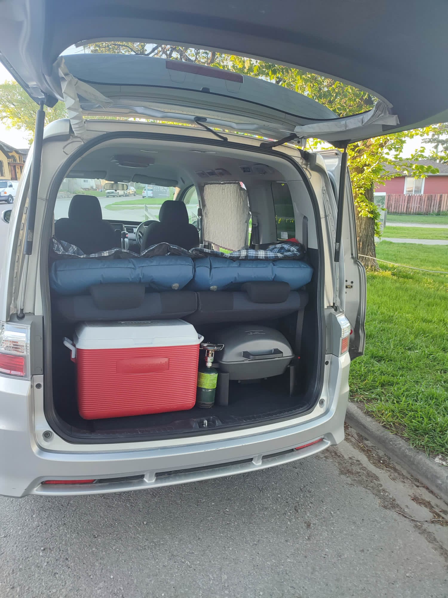 Rear of minivan packed for camping: sleeping pads, cooler, grill ready for an RV rental adventure.. Universal Transformer 2009