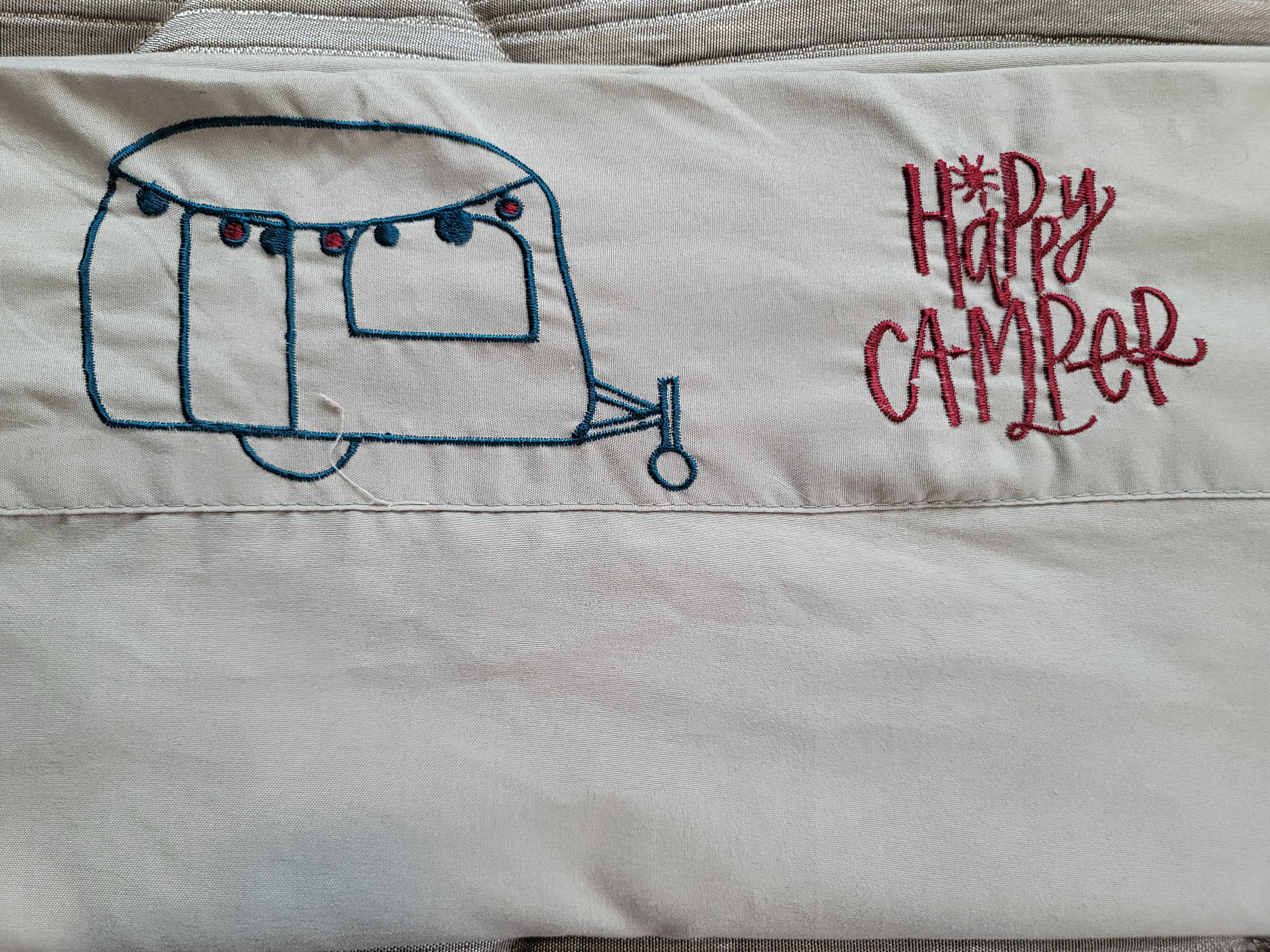 "Happy Camper" embroidered on fabric, showing a teal RV outline with red lights, ideal for an rv rental.. Jayco Jay Flight SLX Baja Edition 2021