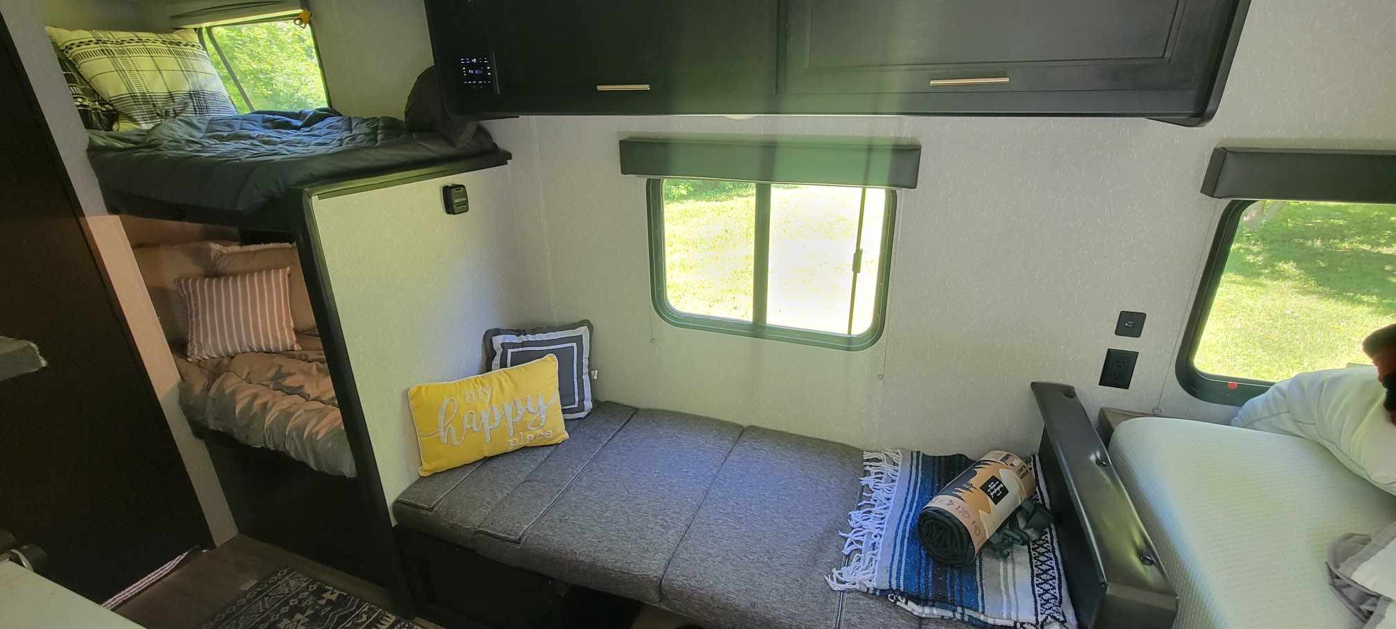 Cozy rv rental interior featuring built-in bunk beds, a flexible lounge/daybed area, and a main bed. Great for family trips.. Forest River Cherokee Wolf Pup 2022