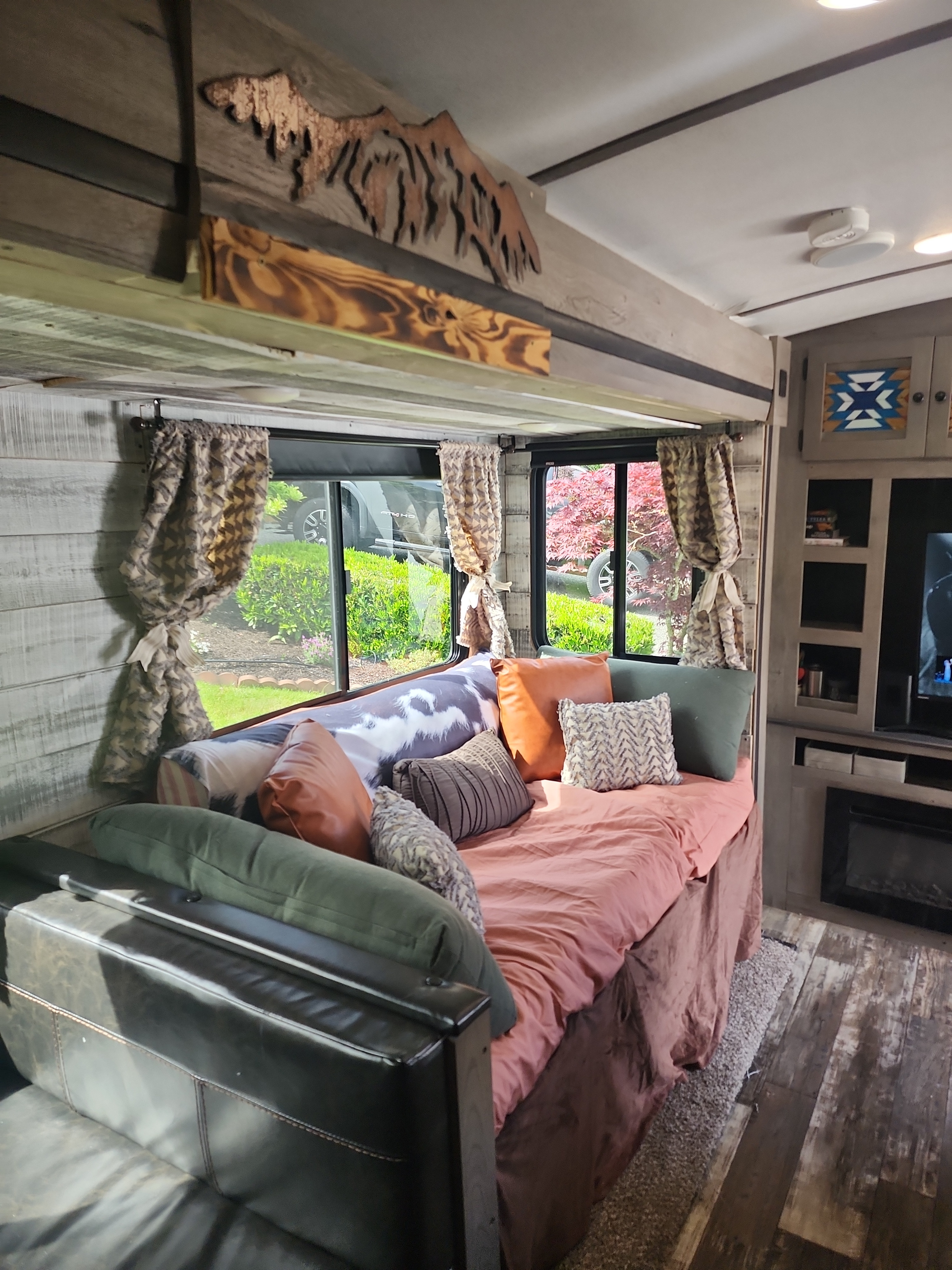Cozy RV rental interior with rustic wood trim, plush lounge, and scenic window views.. Keystone Outback 2019