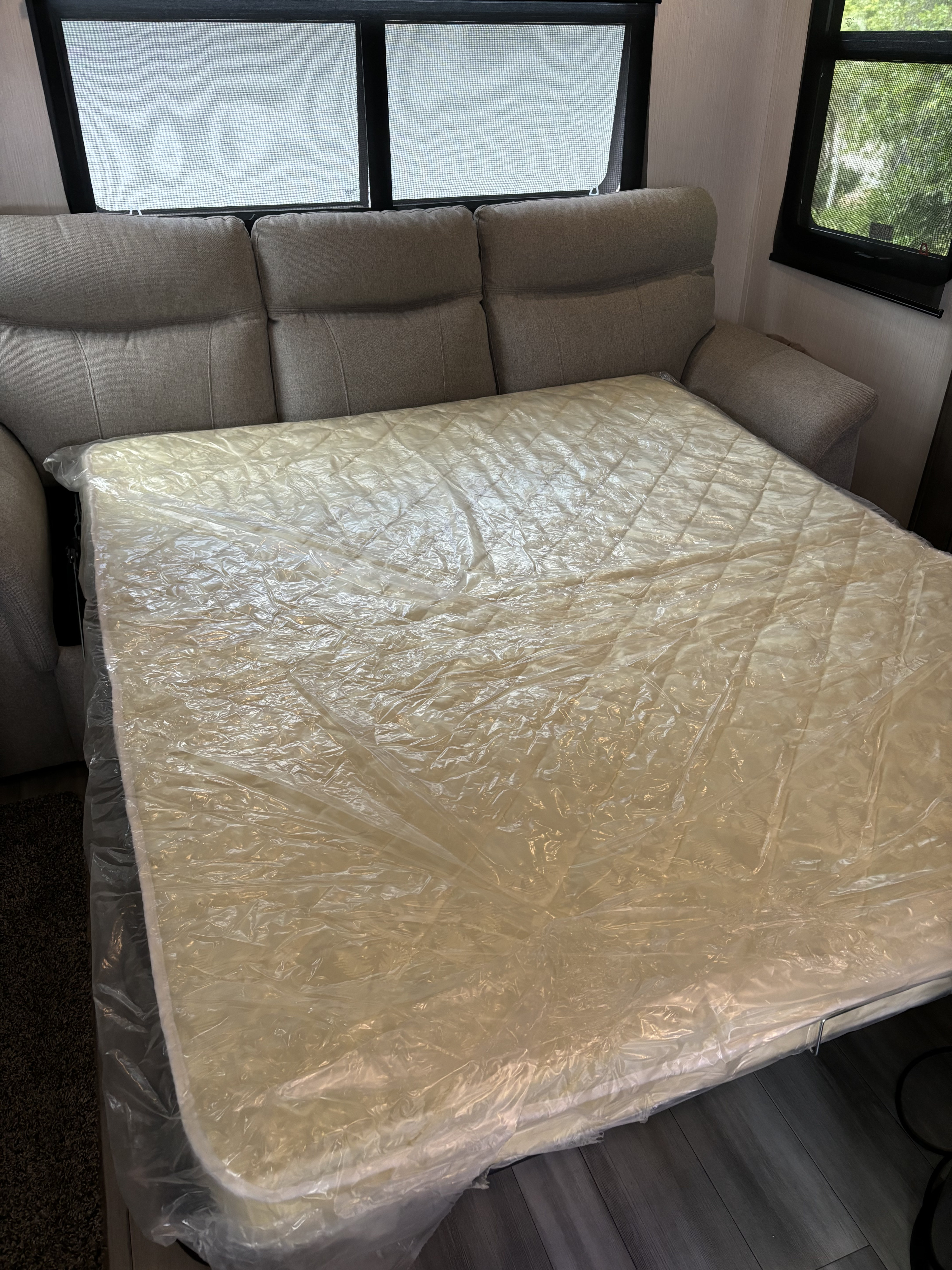 New sofa bed mattress, still wrapped in plastic, pulled out in an RV rental.. Forest River Cedar Creek 311 RL 2022