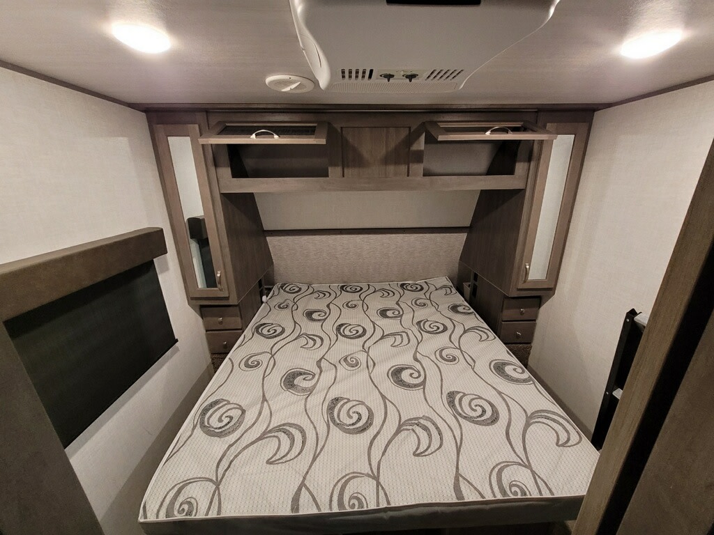RV rental bedroom: compact with bed, overhead storage, and mirrored bedside cabinets.. Alta 2850KRL 2021