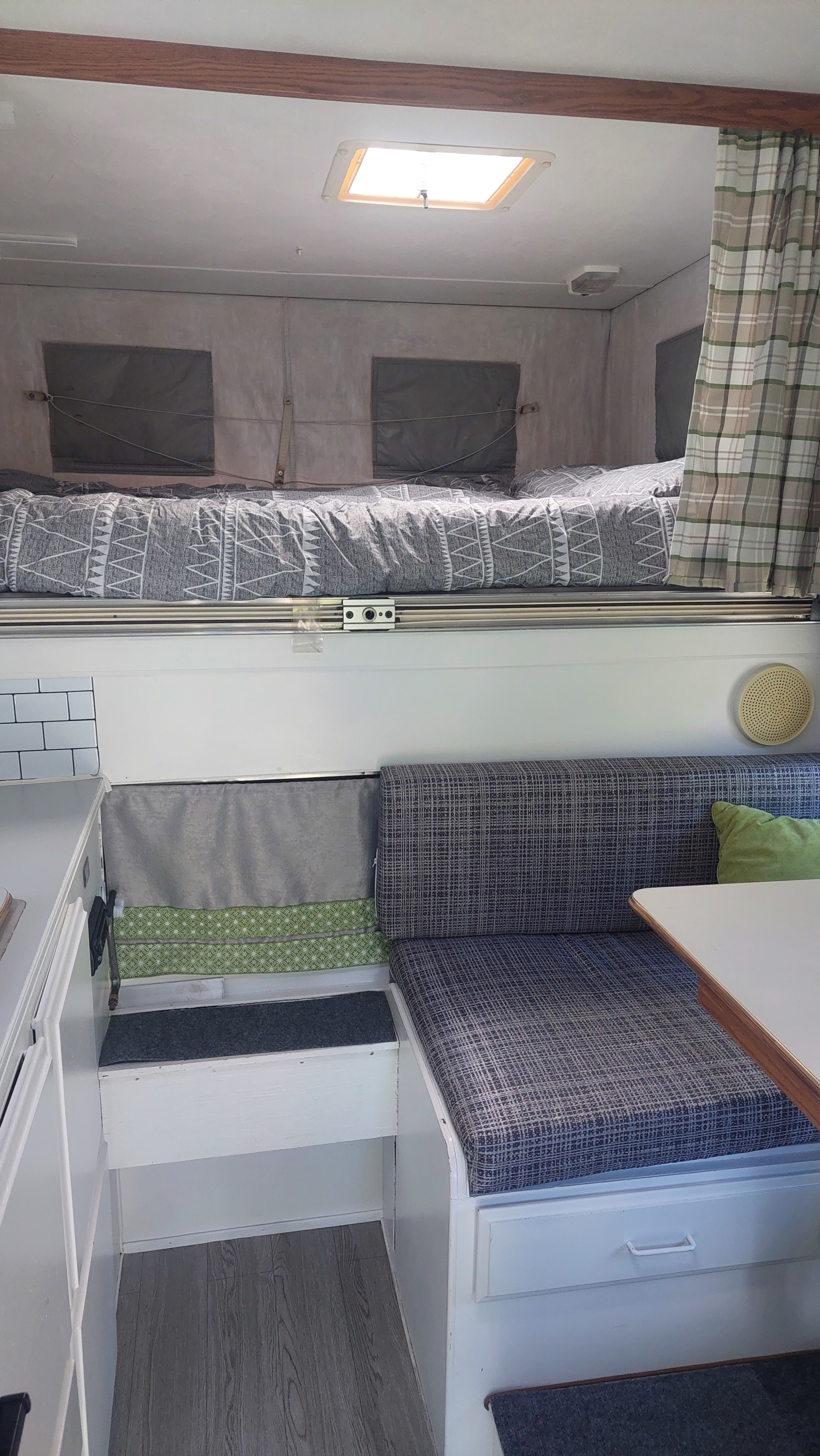 Cozy RV rental interior with an overhead bed, dinette, and functional living space.. Ford F350 2015