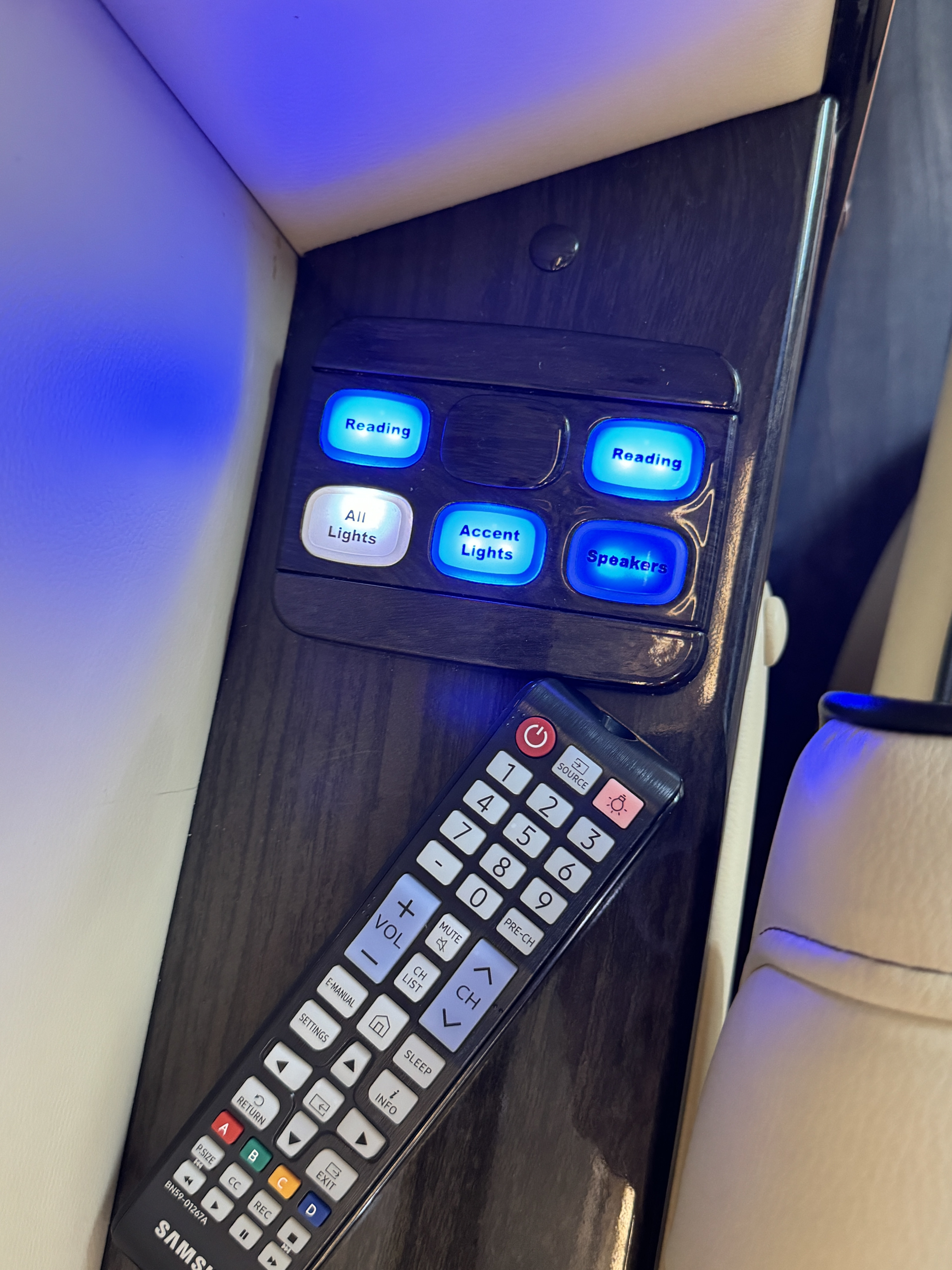 RV rental interior: illuminated control panel for lights and speakers, with a Samsung TV remote for entertainment.. Midwest Automotive Designs Super Sprinter 2019