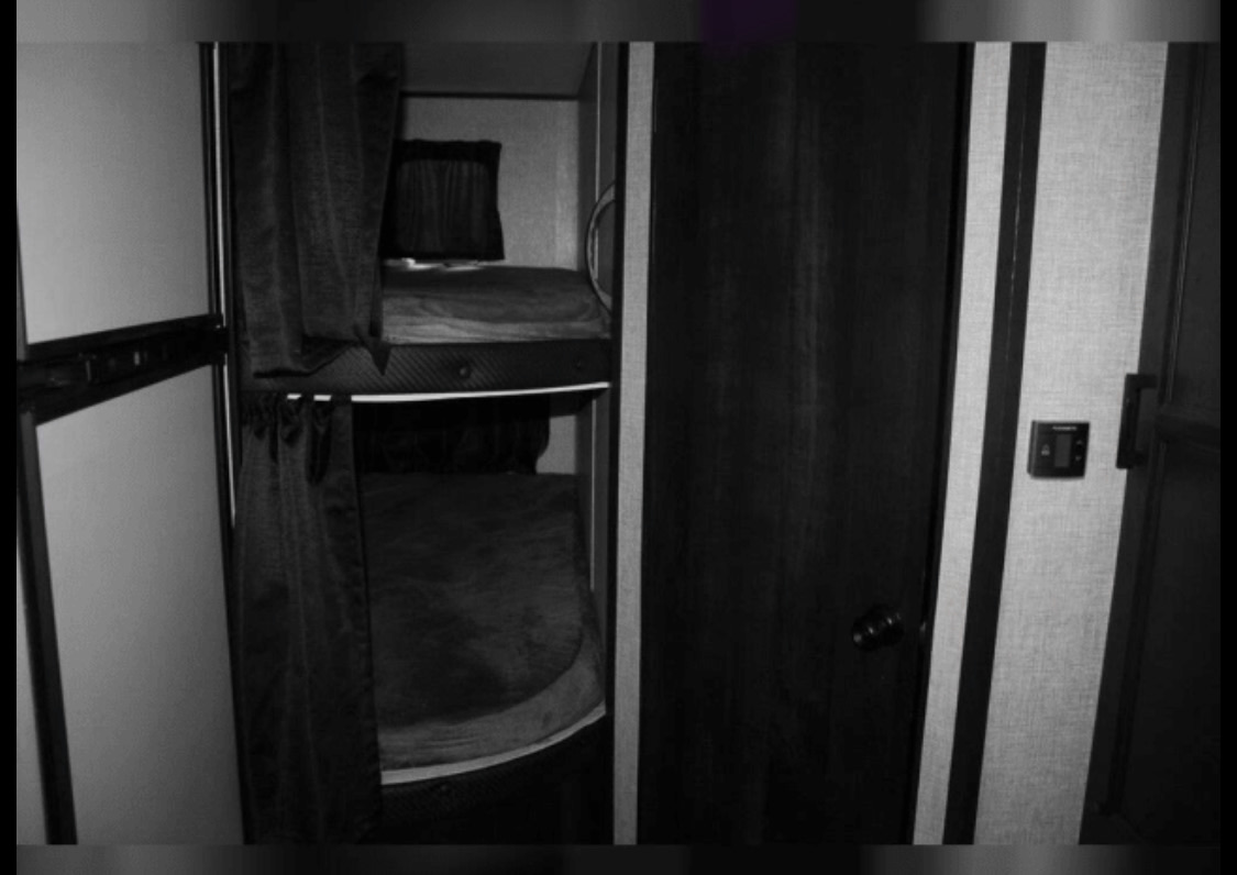 RV rental interior showing two bunk beds with privacy curtains. A compact and cozy sleeping area for travelers.. Jayco Jay Flight 2023