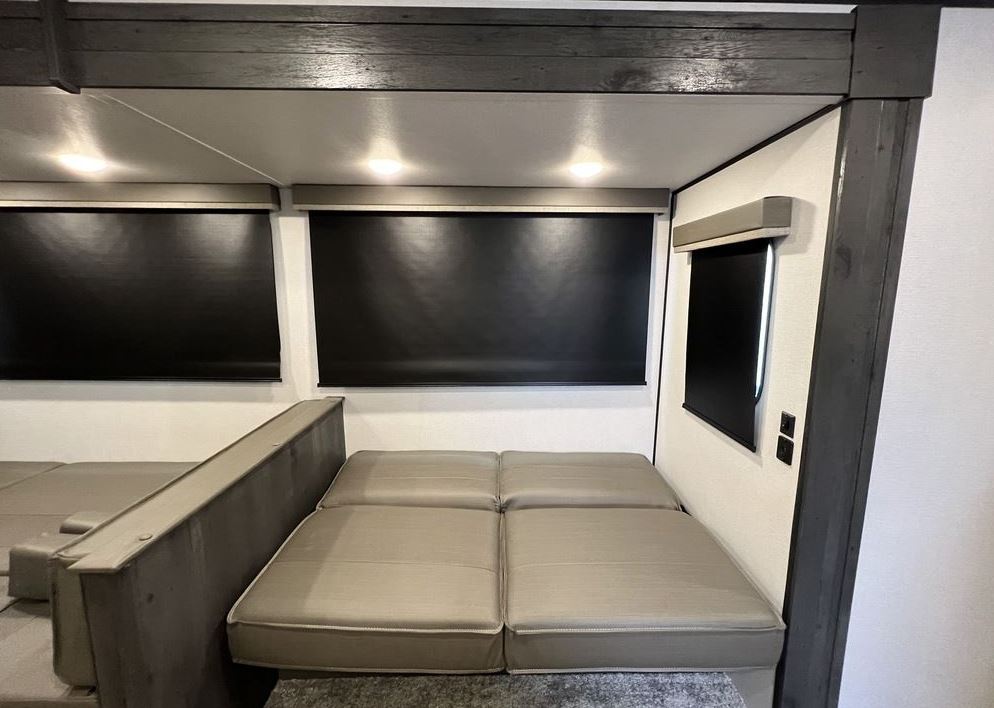 Inside this RV rental: versatile seating/bed, blackout shades, and bright lighting for a comfortable travel experience.. Keystone RV Hideout 2022