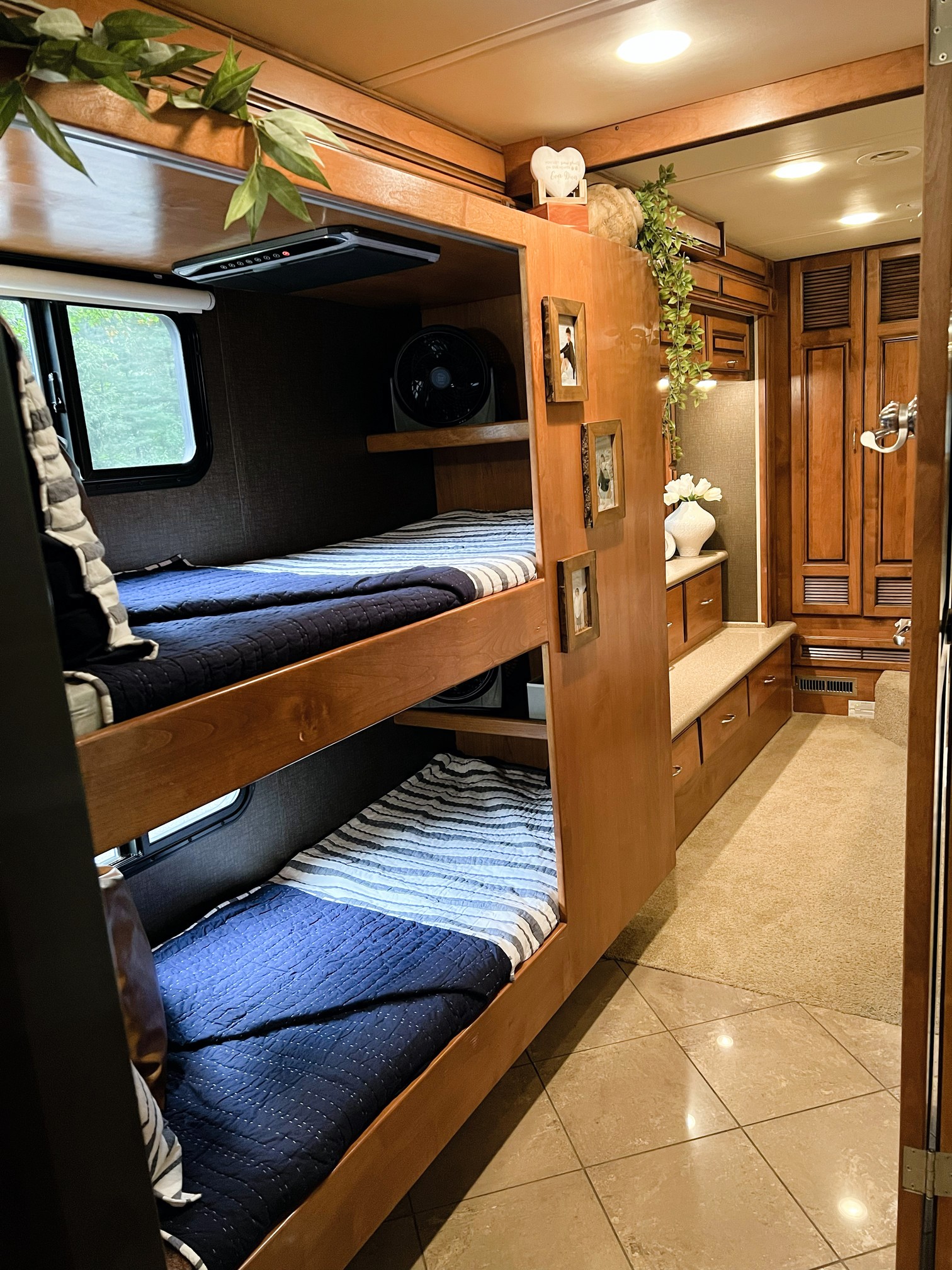 RV rental bunk beds within a wood-paneled interior, creating a cozy and functional space for travel adventures.. Monaco Knight 2011