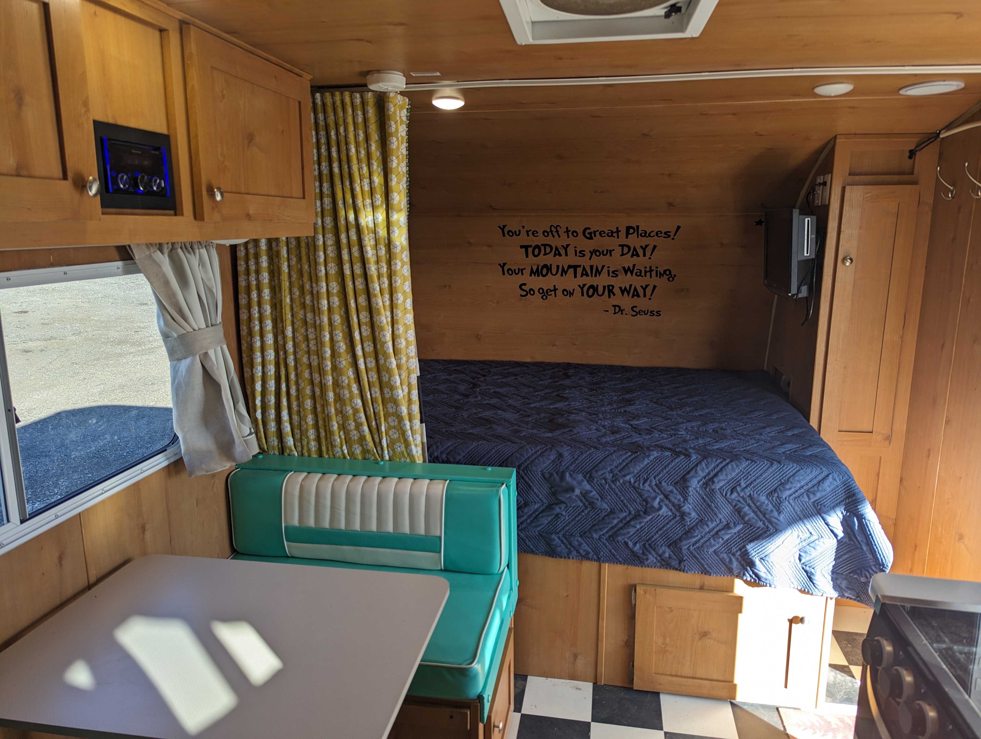 Explore this cozy rv rental interior: wood paneling, a comfy bed, retro dinette, and an inspiring Dr. Seuss quote await.. Riverside Rv Retro 2020